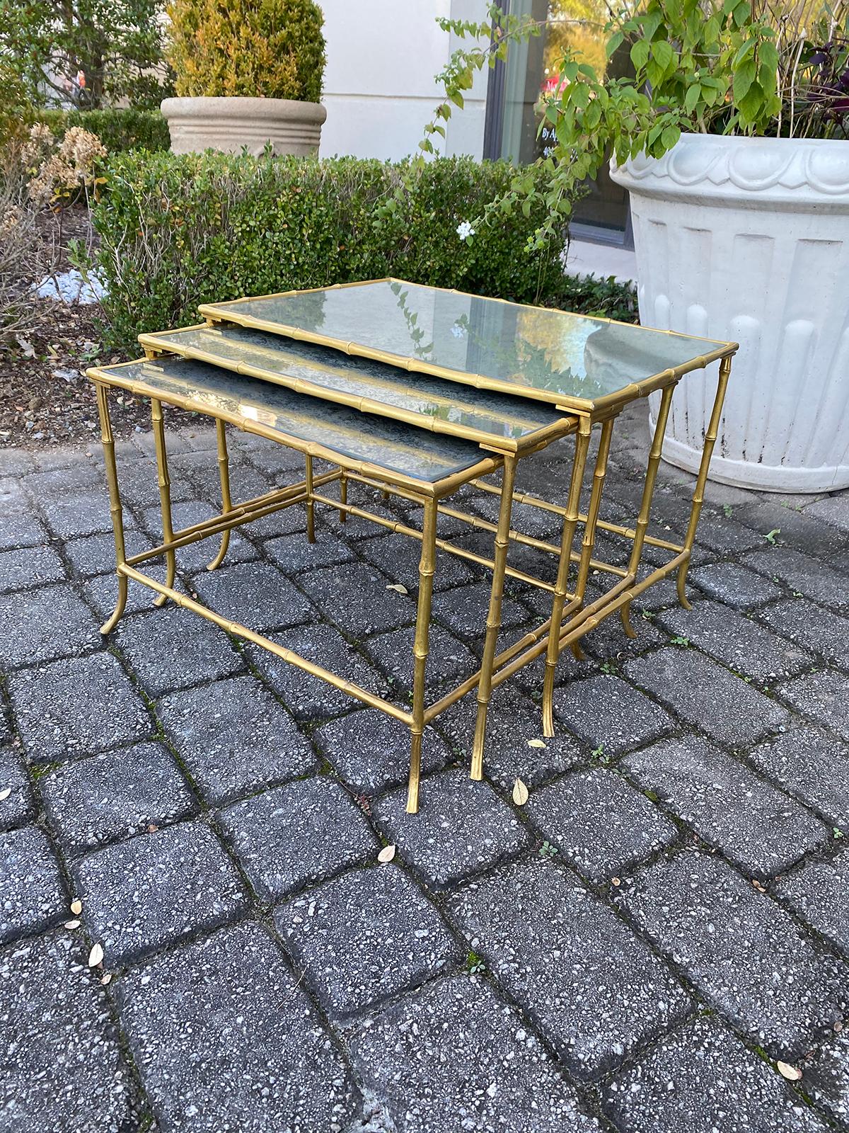 Set of three 20th century Maison Baguès style bronze faux bamboo nesting tables with aged mirror tops
Smallest measures 20.75
