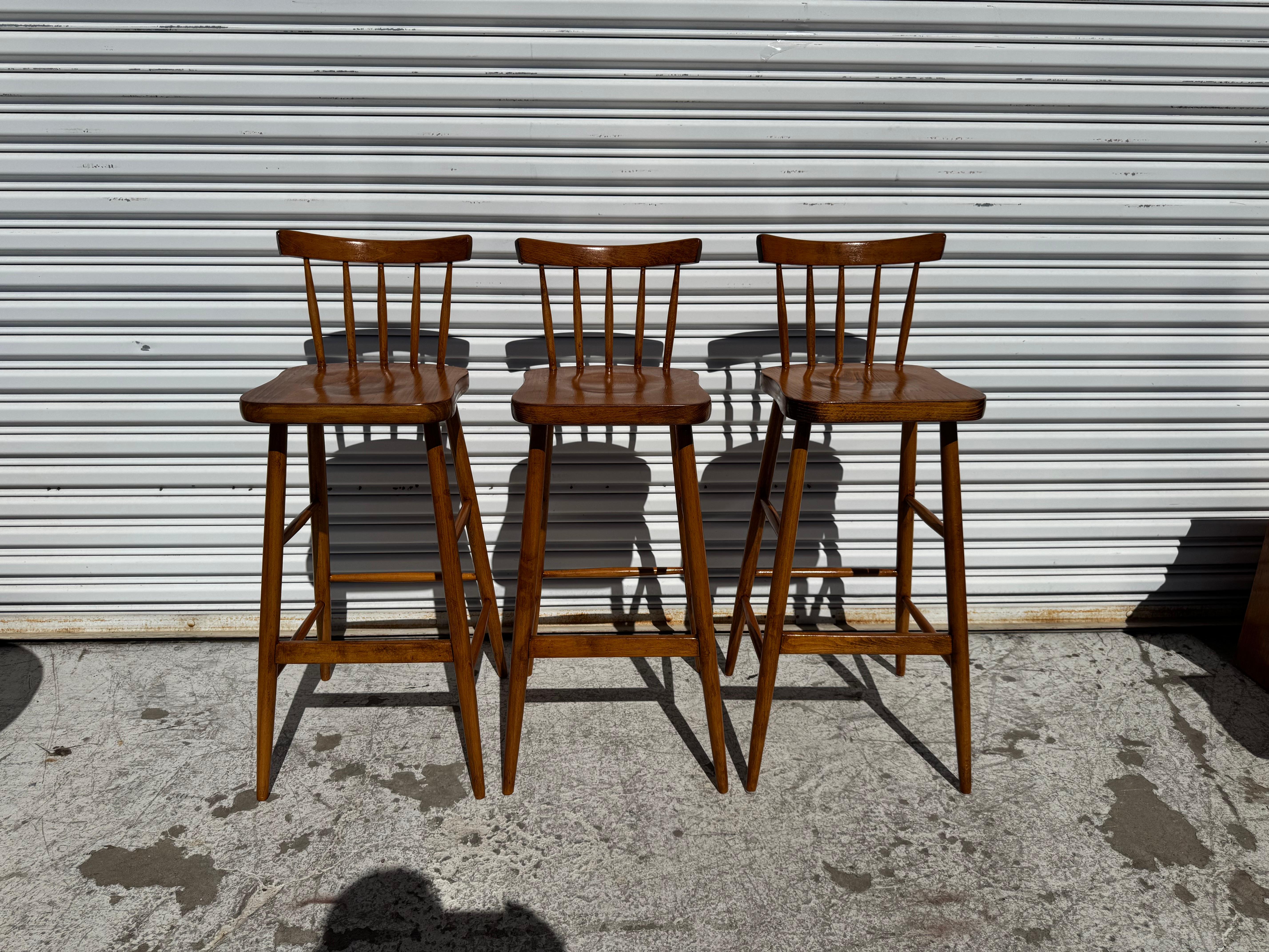 This is a nice set of Spindle back Barstools.
The stools are made of maple.
The mid century style legs have stretchers that 
gives the stools added stability.

 