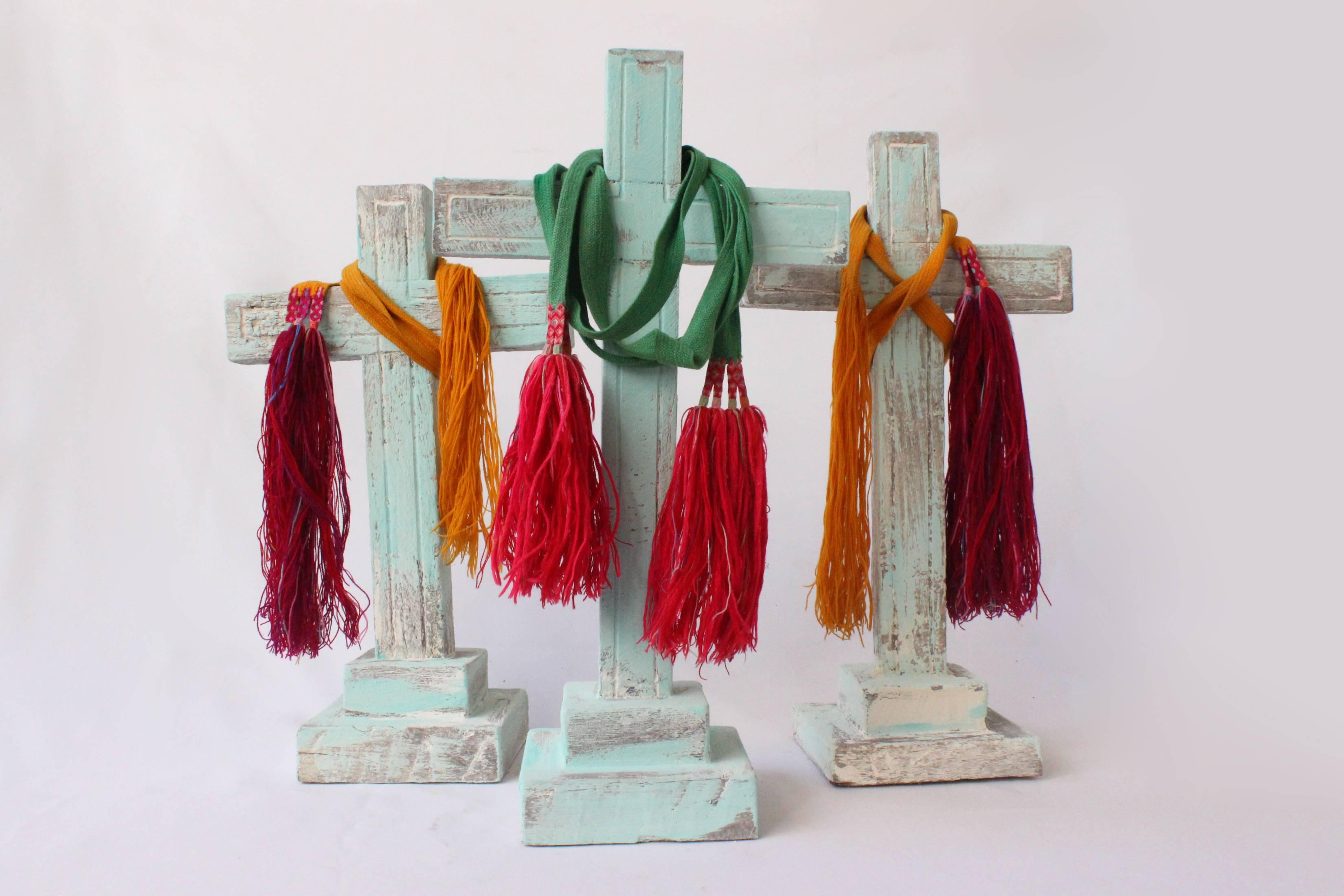 Set of three mesquite wood crosses with colorful indigenous fabrics, quite rare, circa 1900.
