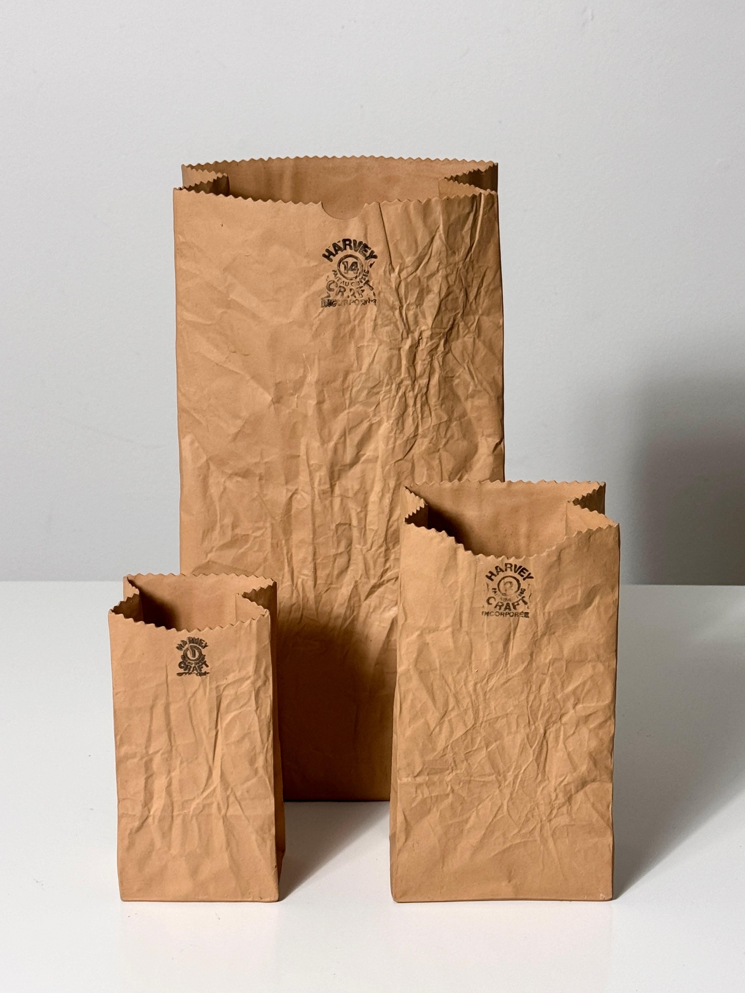 Set of 3 crinkled ceramic paper bag vases designed by Michael Harvey  for Harvey Craft circa 1970s
Unique pop art sculptural pieces with incredible detail
Rare set of all three sizes

sm     3 x 2 x 6