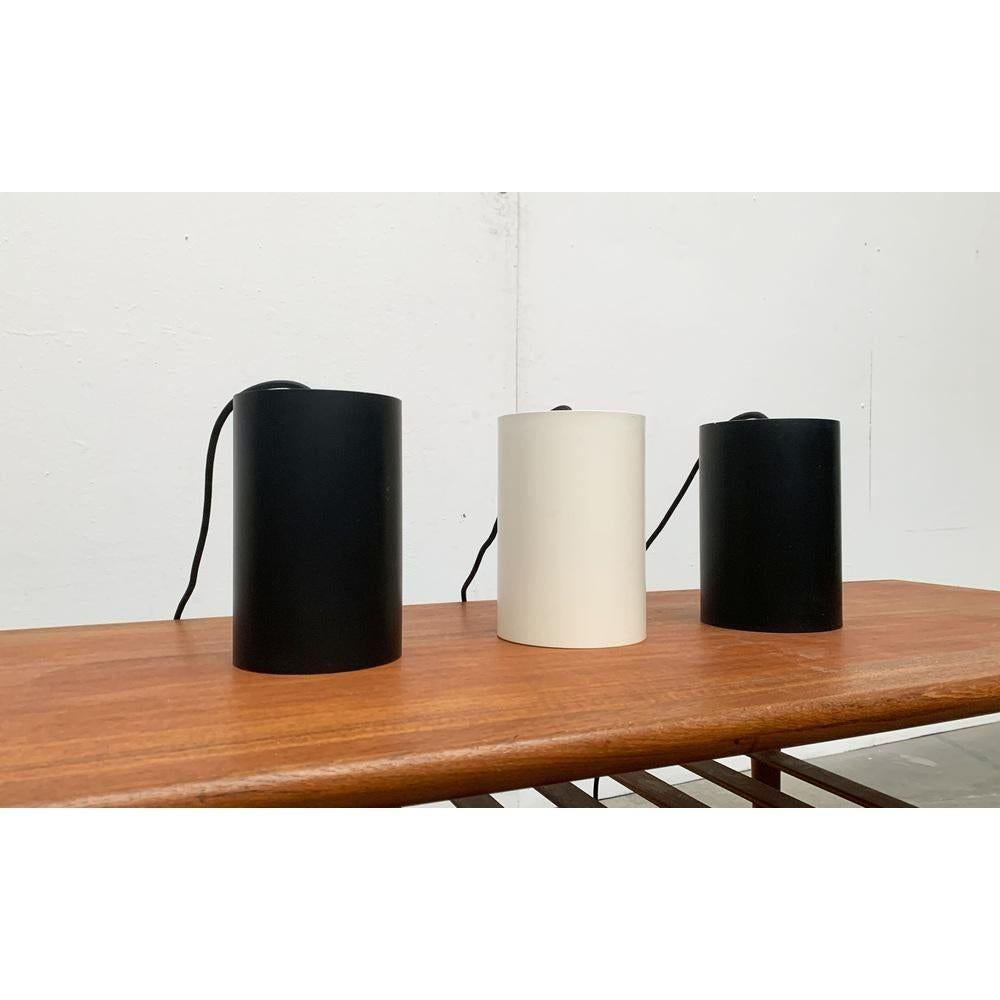 Mid-Century Danish Minimalist Cylinder Metal Pendant Lamps by Eila & John Meiling for Louis Poulsen, Set of 3, in Very Good conditions. Designed 1960 to 1969 This piece has an attribution mark, It is completely authentic for any authenticity issues