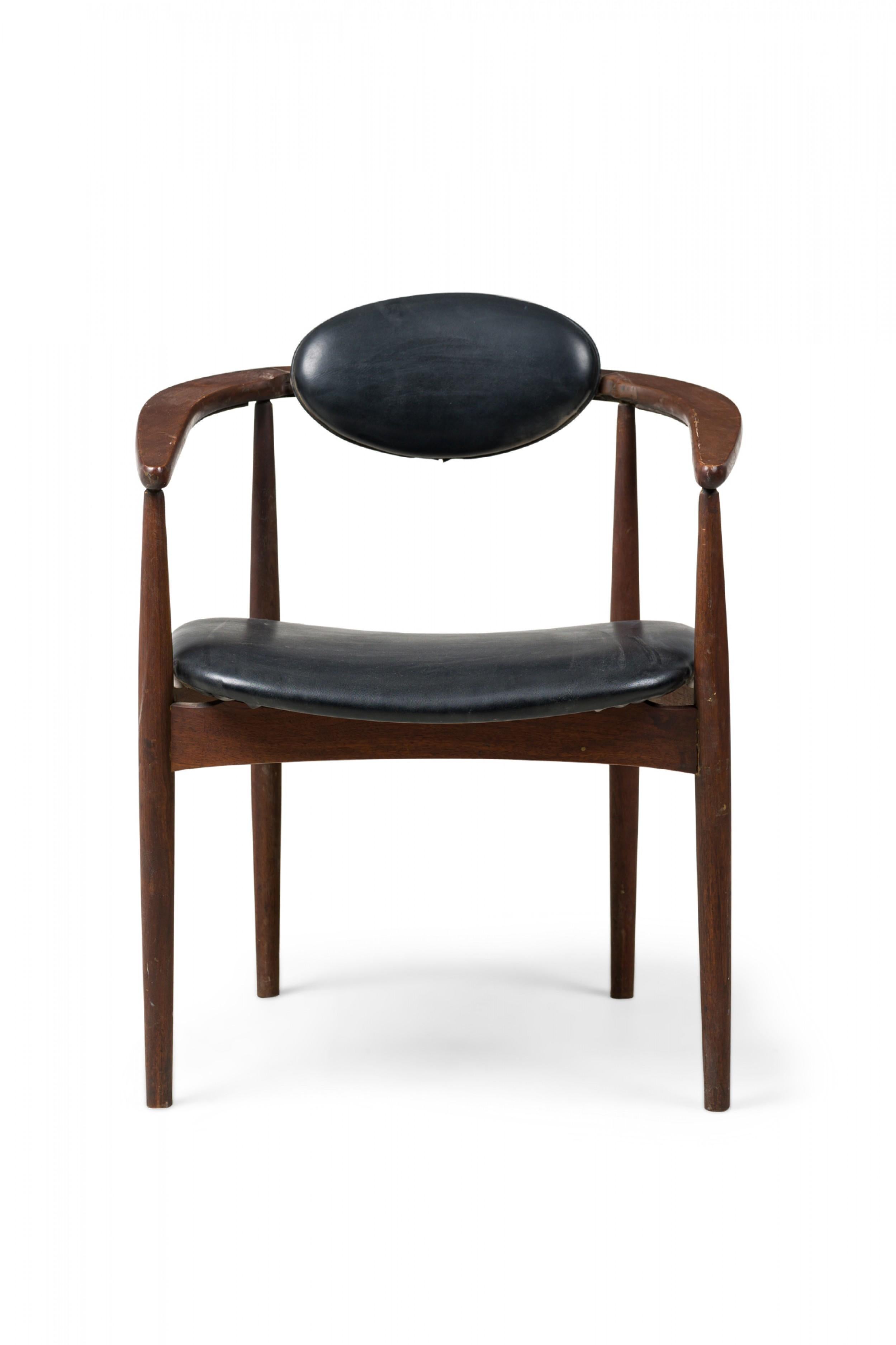 SET of 3 midcentury Danish Modern armchairs featuring horseshoe arms unified with the backrest as one piece, oval backrest and shaped seat upholstered in black leather, standing on 4 tapered cylindrical legs extending to the arms. (in the style of