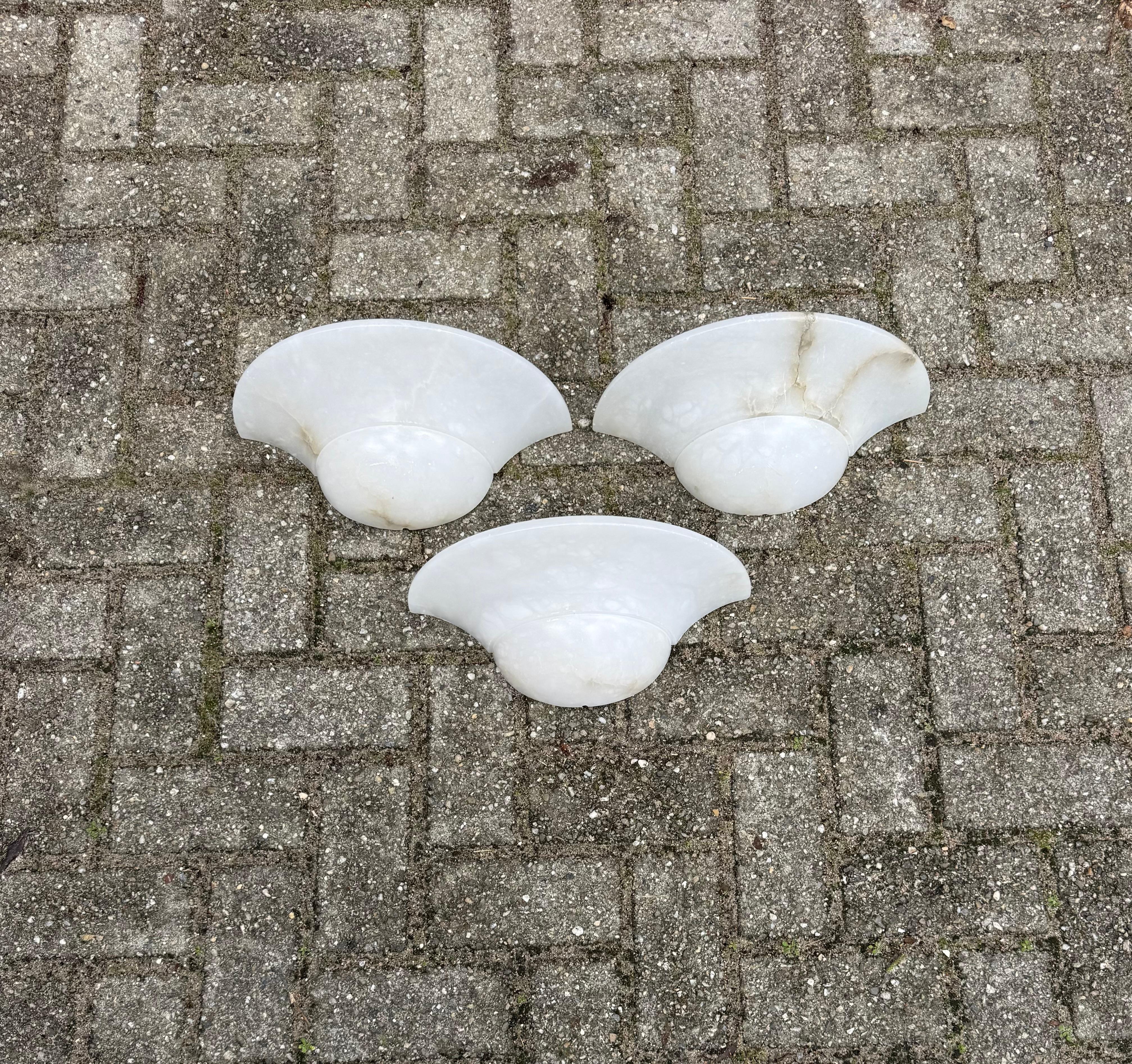 Set of three Mid-Century large alabaster wall lamps, 1970s.

An ideal collection of three alabaster wall lamps.  perfect for an interior design project seeking timeless elegance and natural warmth.
Over the years, we have handled and sold many