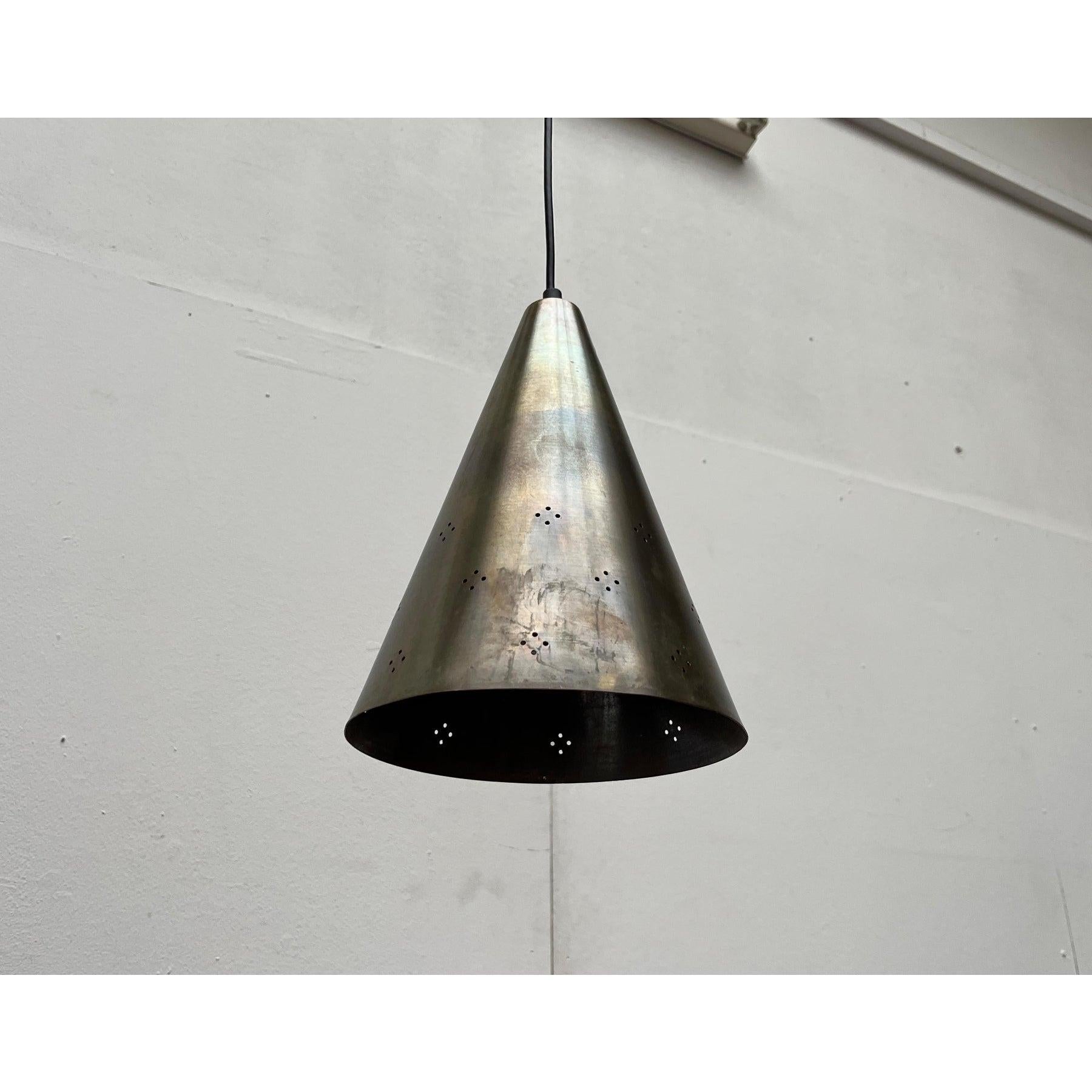 Three mid-century pendant lights made of brass.

A simple design with special materiality. The lights are made of heavy brass and have a simple funnel shape. In the lower half there is a perforation as a subtle ornamentation. The light is primarily