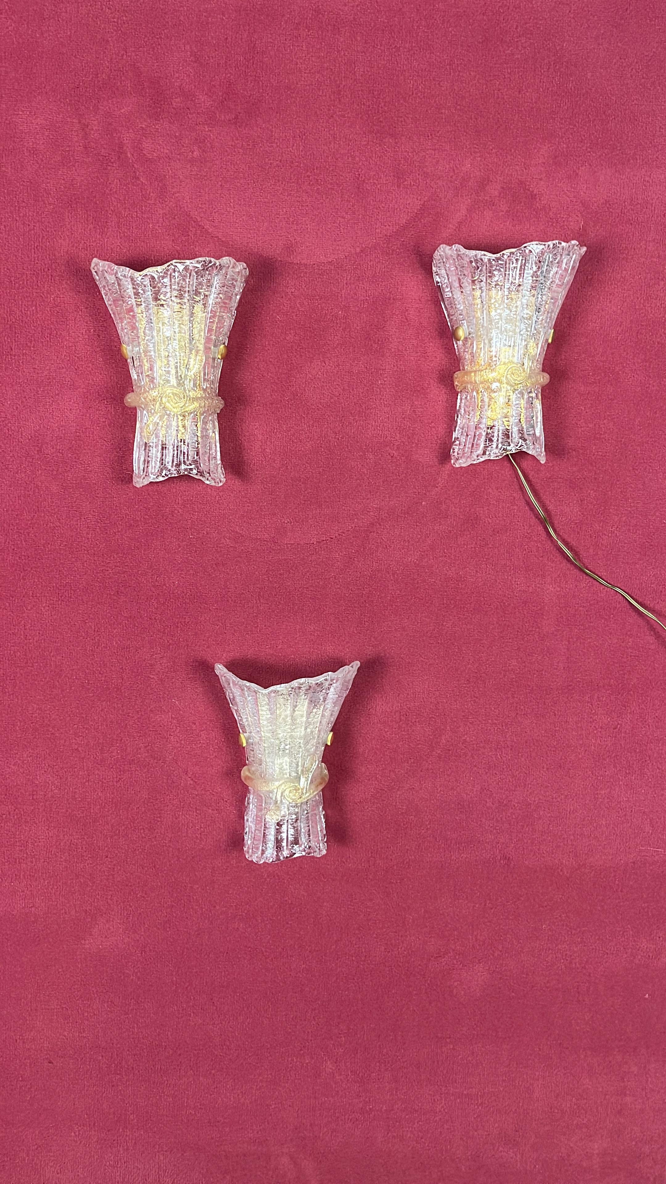 Set of 3 Mid-Century Murano Glass Wall Lamps, 1960s
Golden metal structure, e14 lamps
Intact and in good condition.
Purchased in Venice in one of the most prestigious glassworks.
Manual workmanship demonstrated by the uniqueness of each lamp,