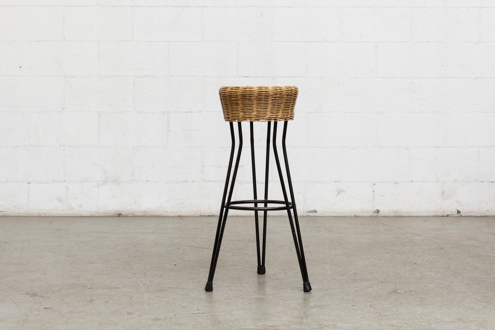 Set of 3 midcentury bar stools with woven rattan seats and black metal hairpin legs. Good original condition with visible signs of wear consistent with its age and usage. Similar single bar stool also available (LU922412763522).
