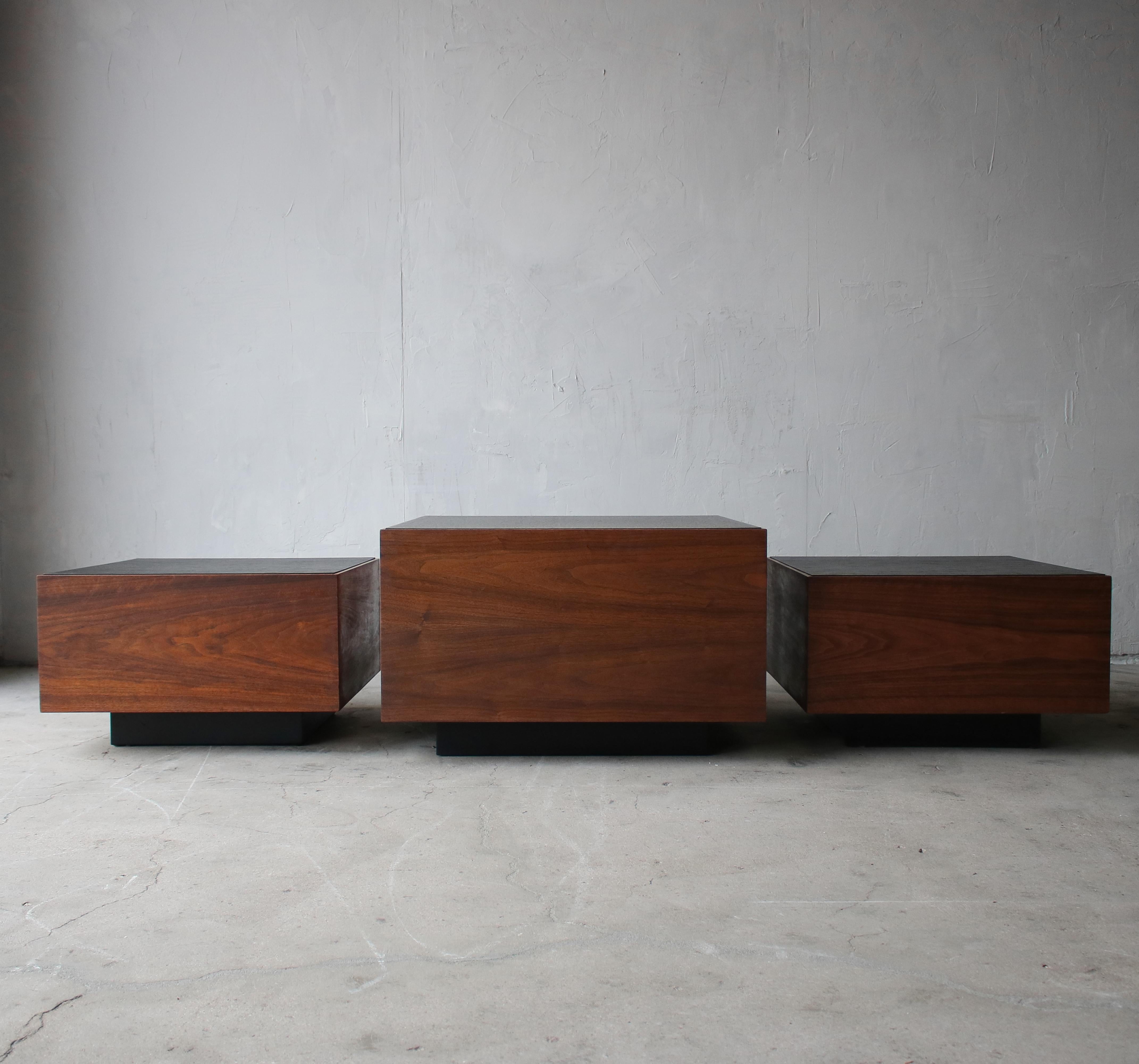 Nice set of midcentury walnut cube tables with black faux slate tops and plinth bases. One small coffee table and 2 side tables. Would be perfect used together as a large coffee table. 

Tables are in great condition showing very little