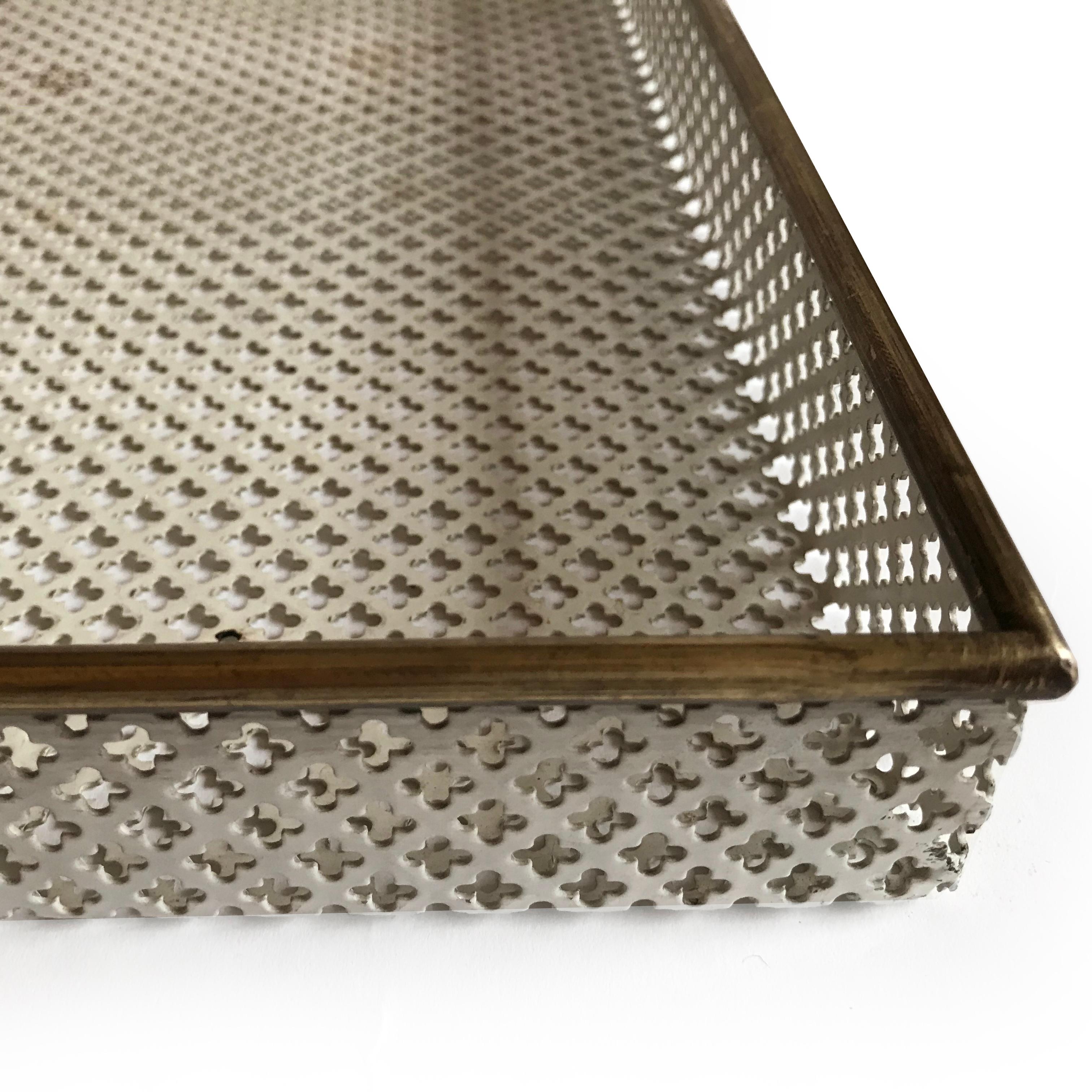 Set of 3 perforated metal trays, in original paint with brass rims. By Mathieu Matégot, circa 1950.

Largest: 58 x 39cm.