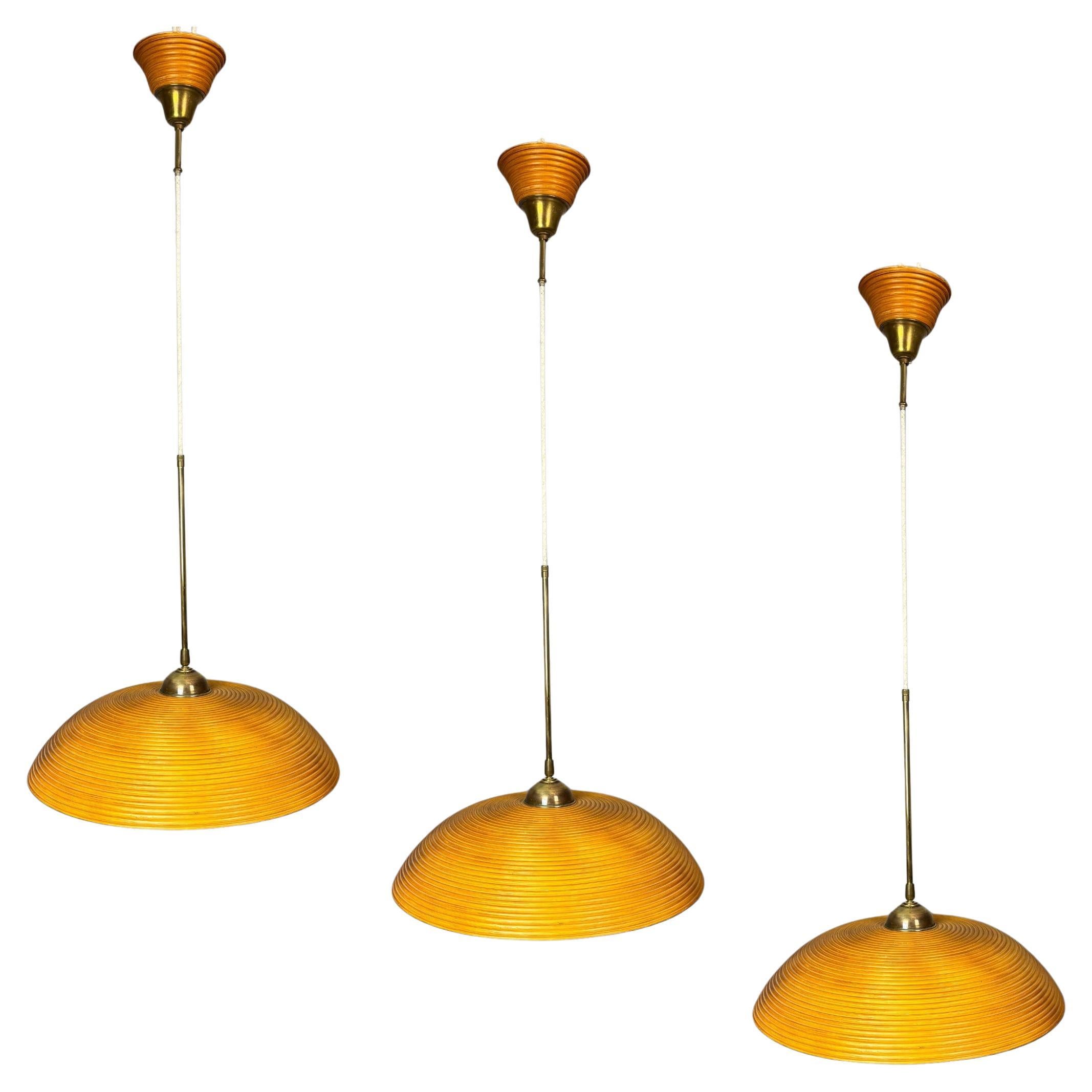 Set of 3 midcentury rattan bamboo pencil reed hanging pendants, Italy 1970s in vendita