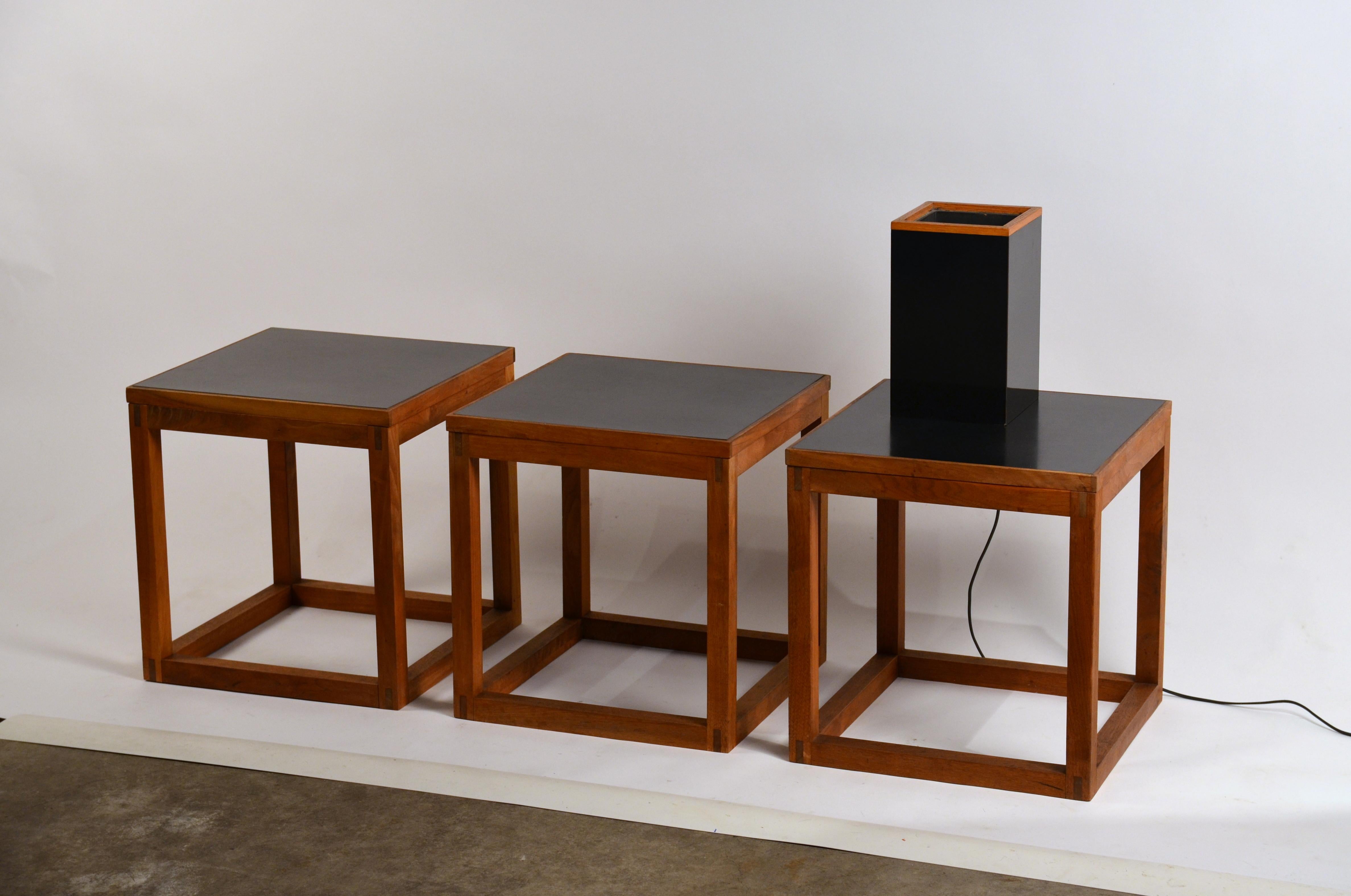 Set of 3 minimal teak and black laminate side tables. Matching bonus lamp included.

Dimensions listed are for each table.

The lamp is 6 in. wide x 6 in. deep x 10 in. tall.

Versatile minimal design. Can also be used as stools or a 3-part coffee