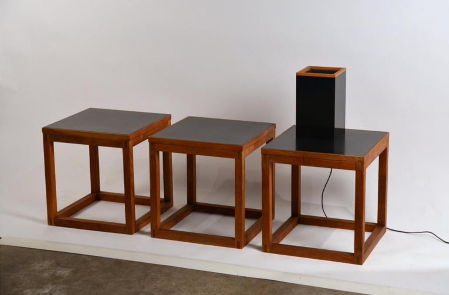 Set of 3 minimal teak and black laminate cube side or end tables. Matching lamp included.

Dimensions listed are for each table.

The lamp is 6 in. wide x 6 in. deep x 10 in. tall.

Versatile minimal design. Can also be used as a 3-part coffee table.