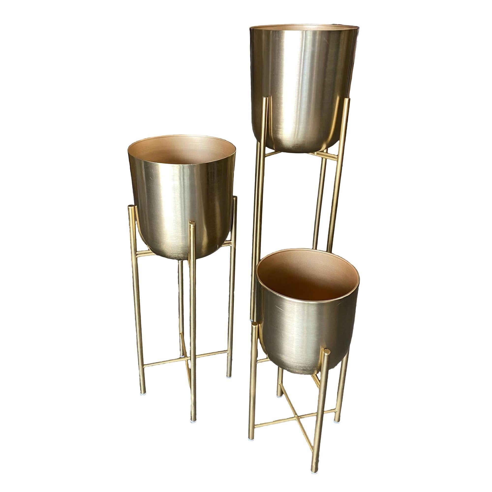 Set of 3 Brutalist chrome foil cylinder planters with a chrome foil finish and black plastic caps by H.U.D.D.L.E. OF Los Angeles.

Measures: Large: 40