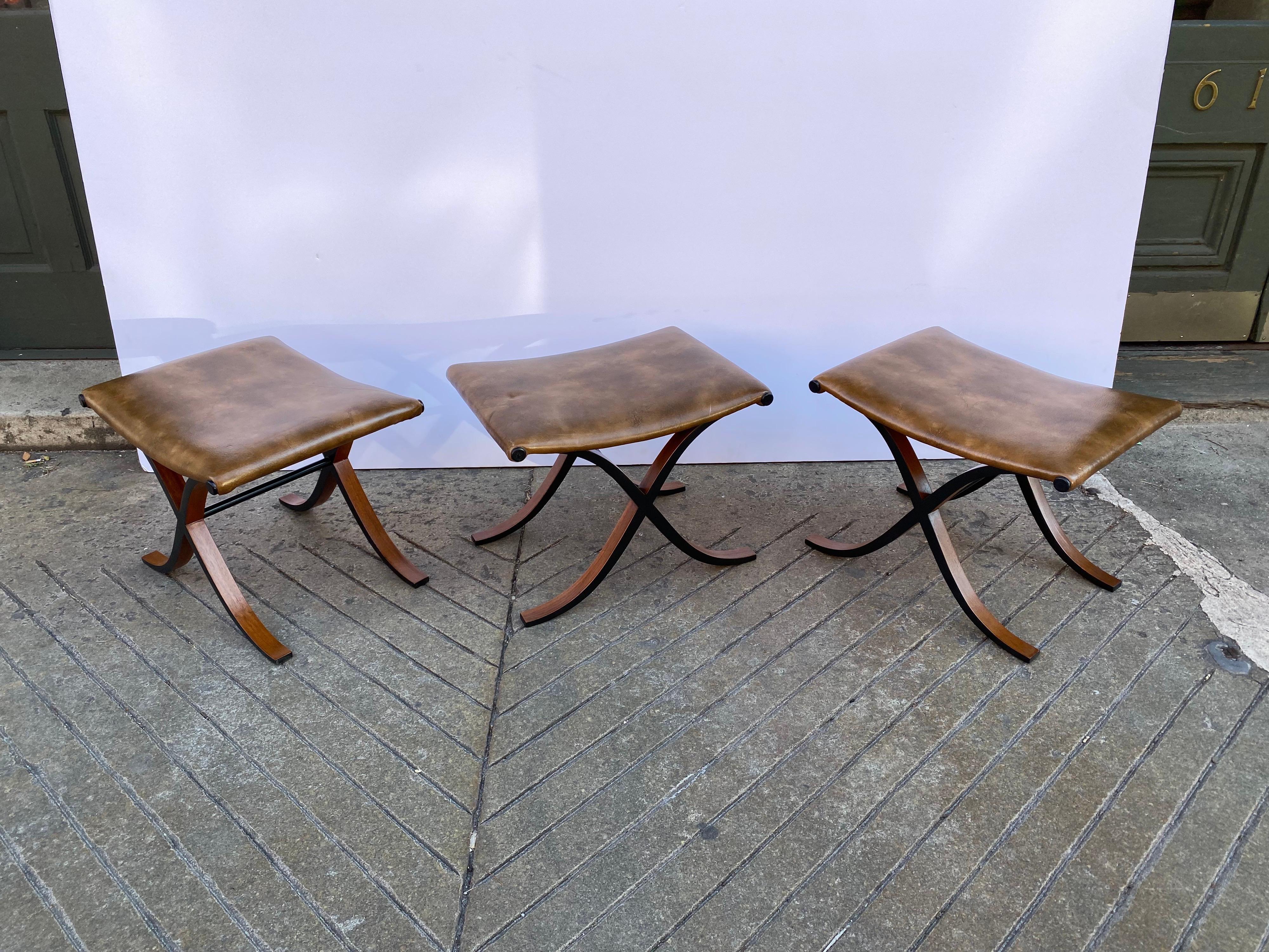 Set of 3 molded plywood and walnut curule stools or ottomans. Newly refinished frames with their original Brown vinyl Covers. Classic Roman Form reinvented in a Modern Fashion. Very solid and elegant!