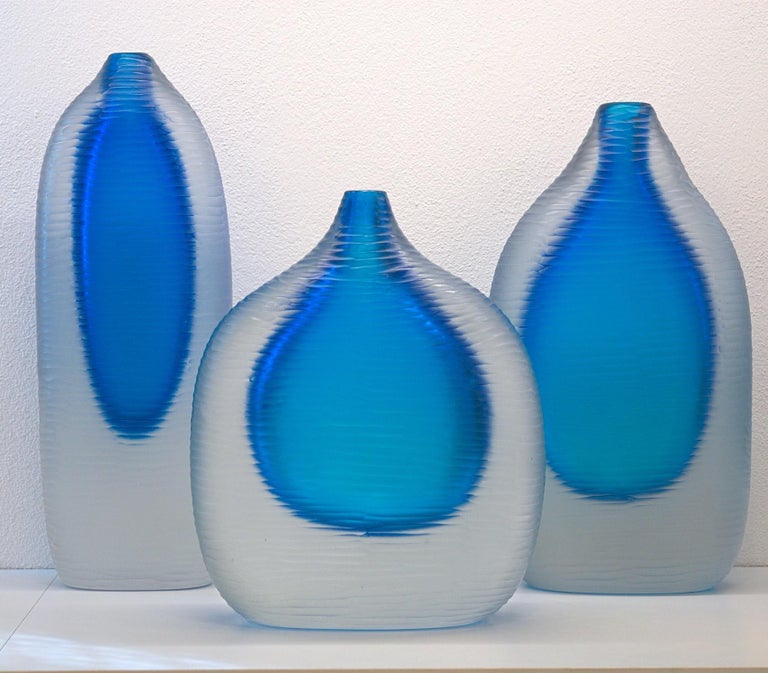 Sculptural group of three Sommerso vase. The inner color is a aquamarine framed by a massiccio body of clear glass.

Each vase is completely finished in horizontal battuto.
Great masterpieces with difficult technique, mixing the sfumato and the