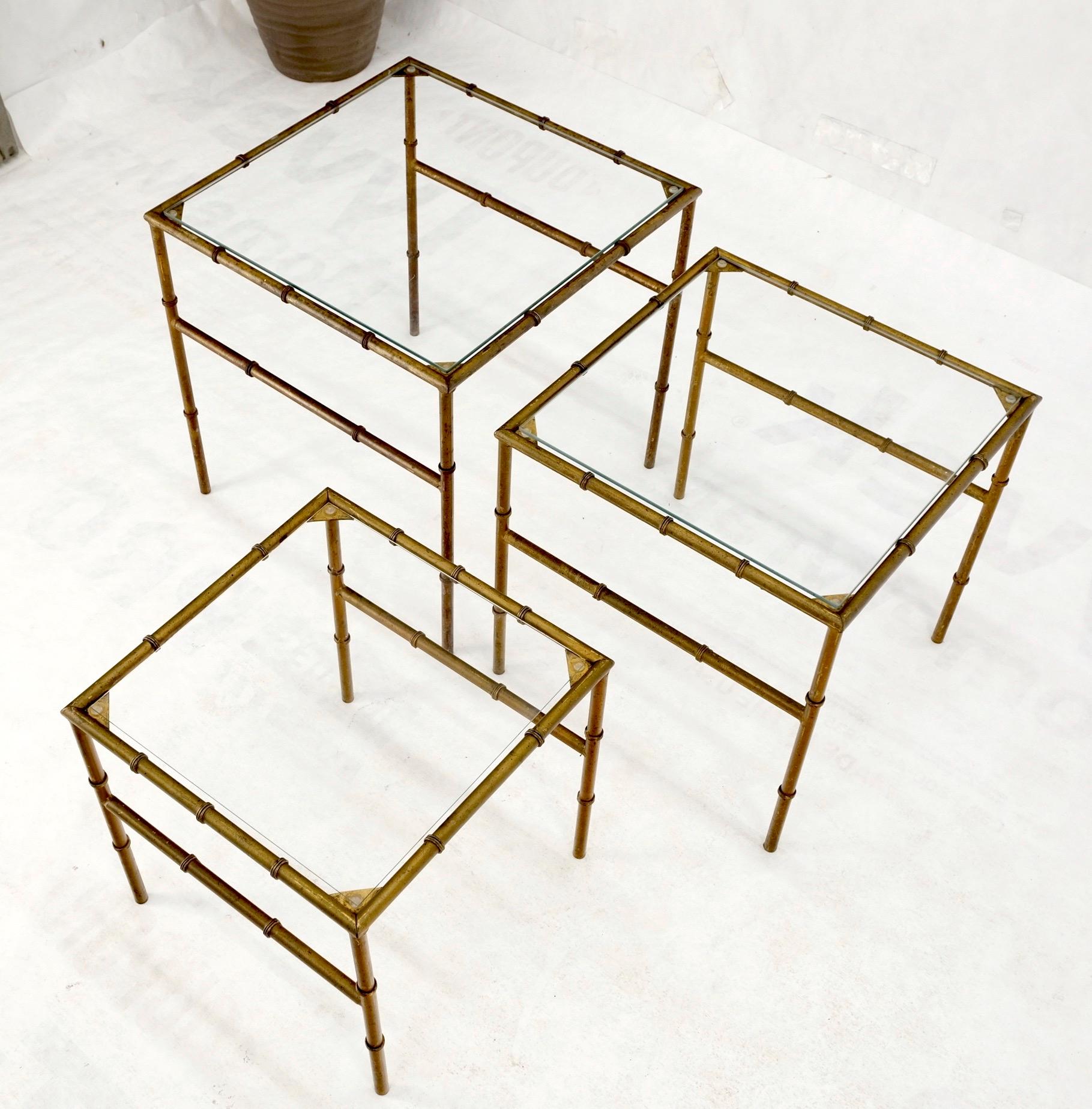 Set of 3 Mid-Century Modern nesting glass top faux bamboo gilt metal end side stacking tables.