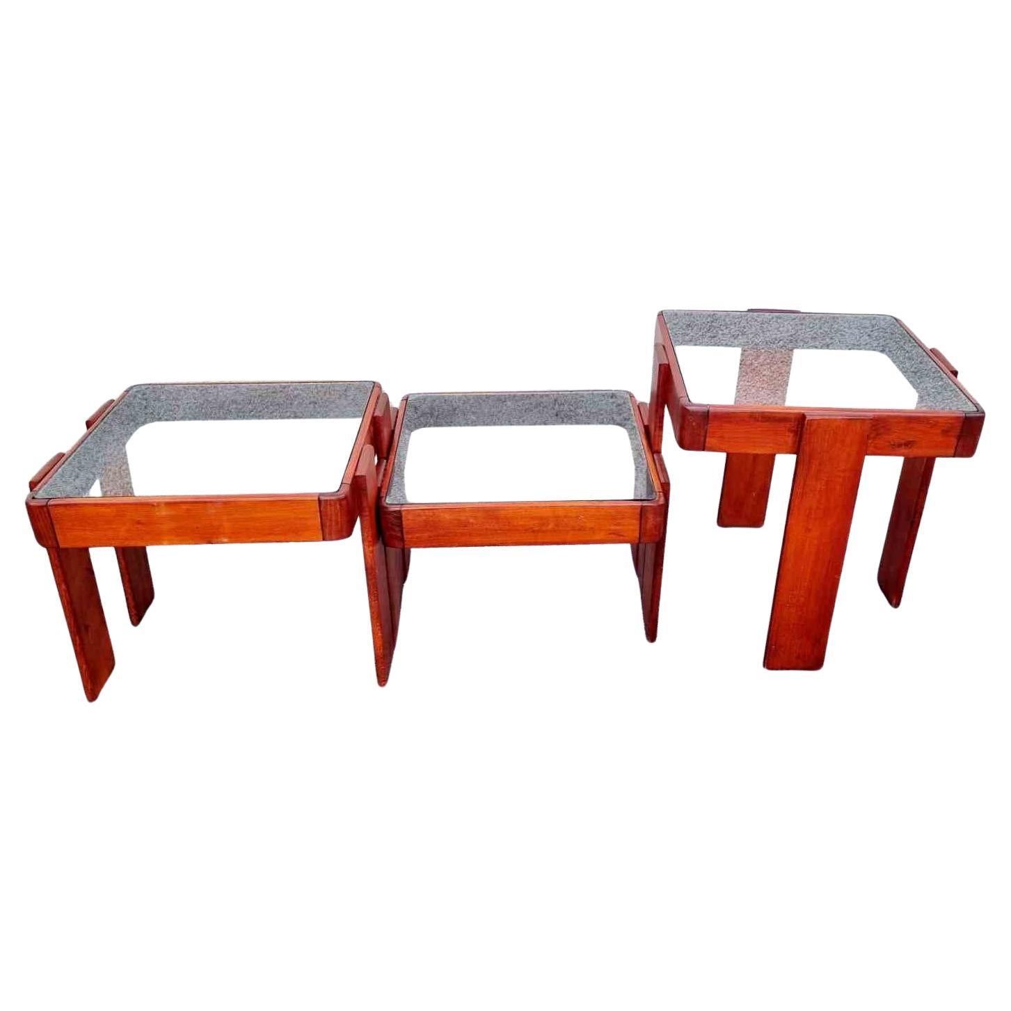 A set of three coffee nesting tables made in Meblo furniture factory in the former Yugoslavia. The tables are designed by Gianfranco Frattini for Cassina. 
Gianfranco Frattini is an Italian architect who was part of the biggest Italian design