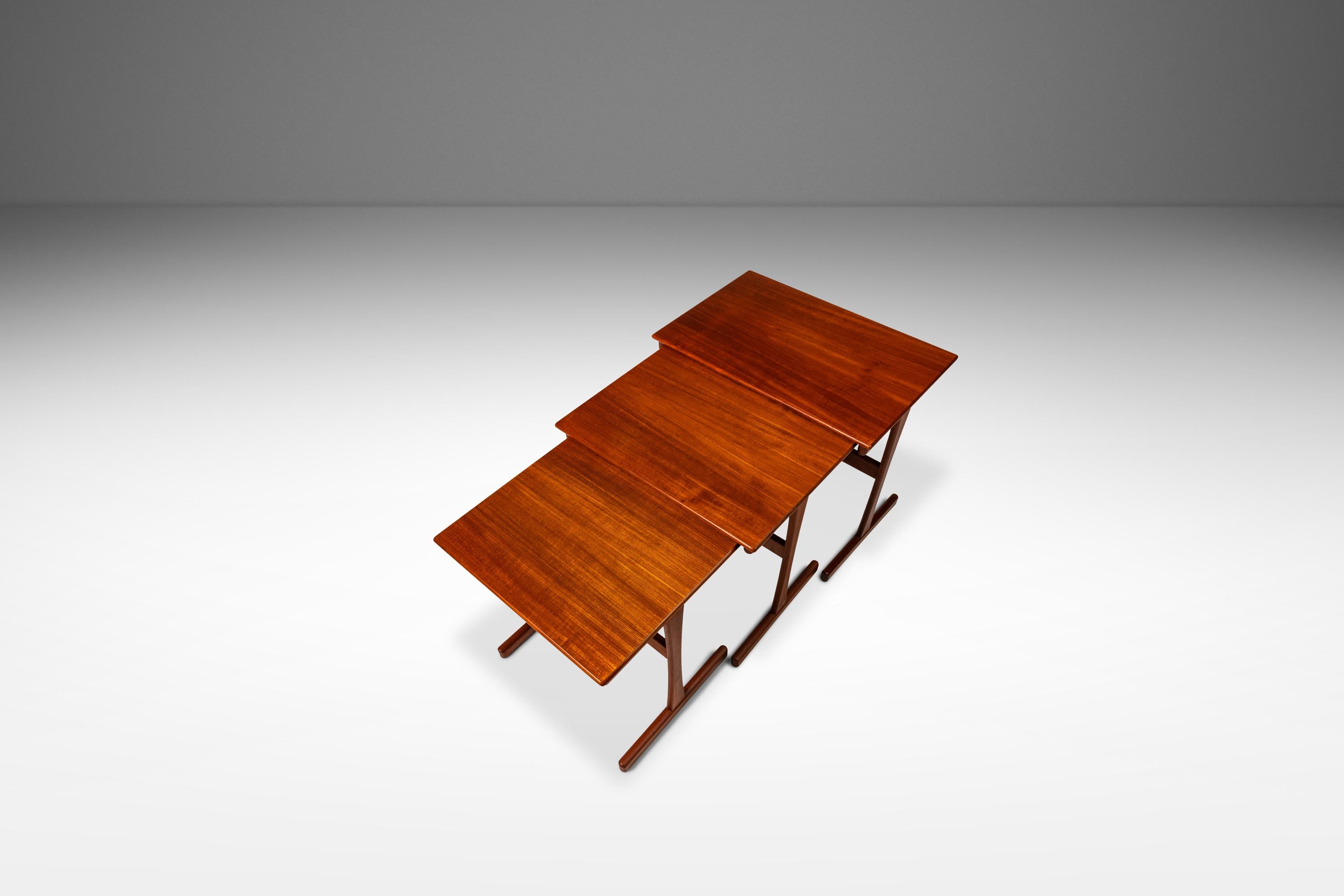 Introducing a set of three nesting tables designed by the incomparable Kai Kristiansen for Vildbjerg Møbelfabrik. Designed and crafted in Denmark during the early 1960's, this set is in rare, stunning original condition is ideal for collectors and