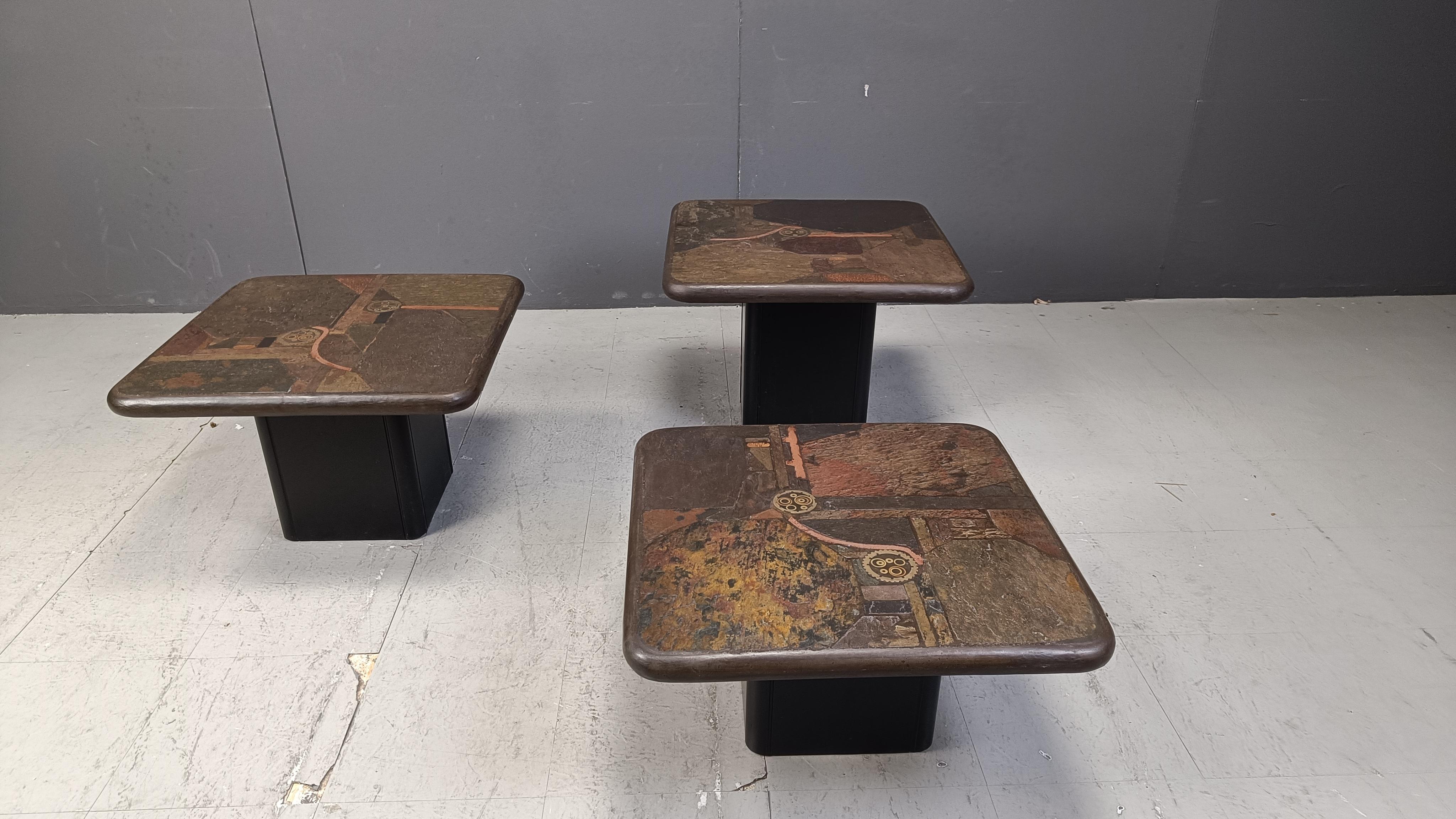 Set of 3 of brutalist side tables or nesting tables designed by Paul Kingma and produced by Kneip. Signed Kneip 1990

The tables are made of mosaic slate ston tops with inlaid copper and rest on wooden bases.

1990 - Germany

The tables are in good