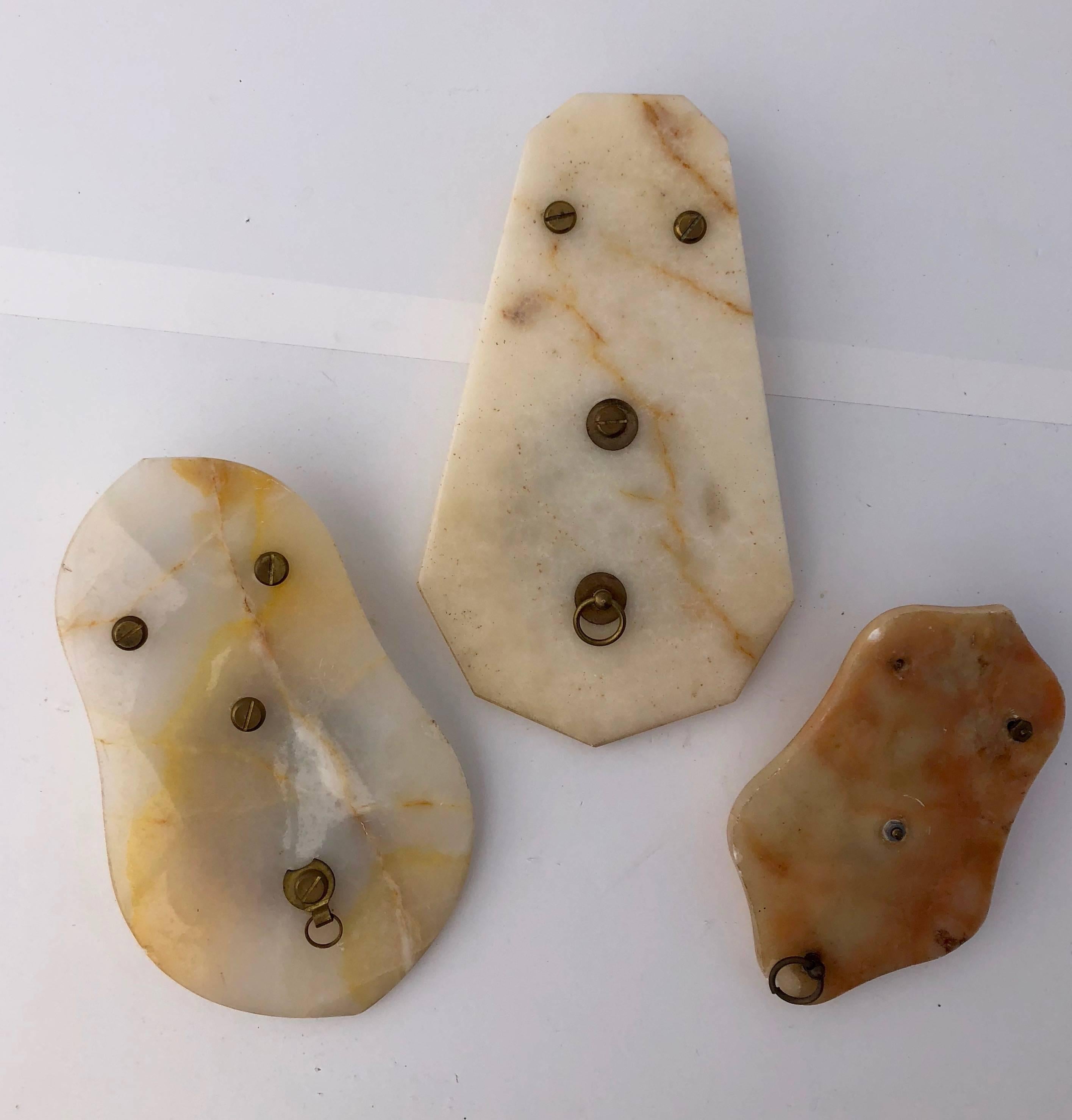This lovely set of French Onyx holy water benetiers feature medallions with gilt detailing and glass fonts. Onyx is a type of fragile marble with veins and multiple colors. No two pieces of onyx are ever the same and one slab can include multiple