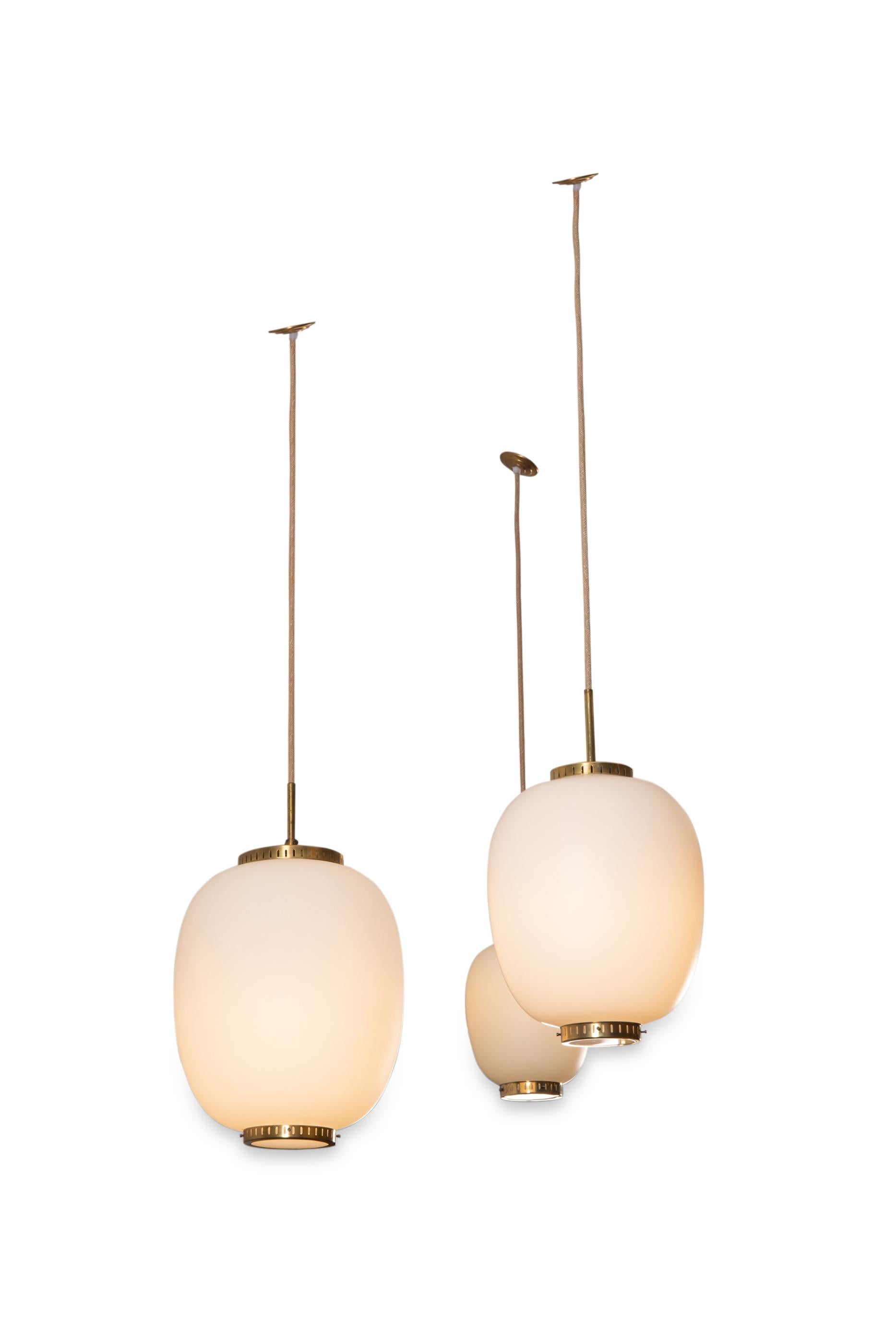 3 opaline glass and brass ceiling fixtures. 
3 items now available,
See dimensions below 
By Bent Karlby for Lyfa. 
Denmark, late 1950s 

 dimensions available: (Height of the opaline and brass disc) 
Medium (2 available ): H 11.8 in. (30 cm); D