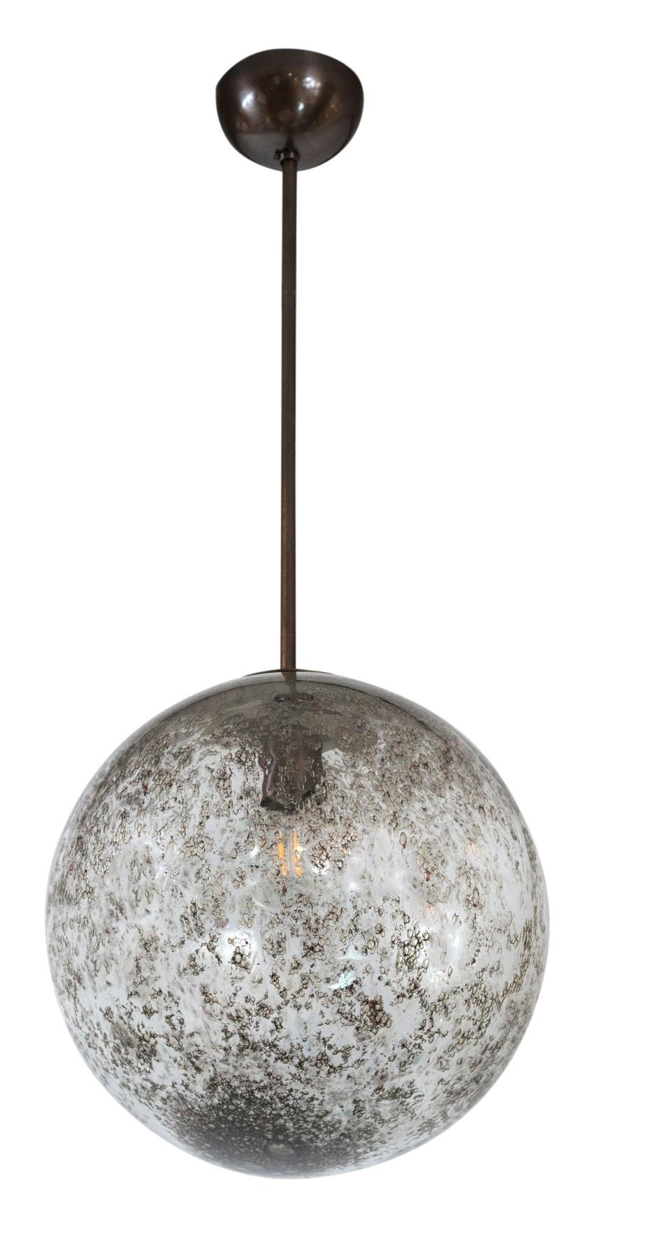 Lovely round globe lights blown with brass to create transparent dark brown mottling effect, each one unique and fabulous in a series. Fitted with dark bronze lamping, electrified for high wattage with the use of  LED bulbs and sold as electrified