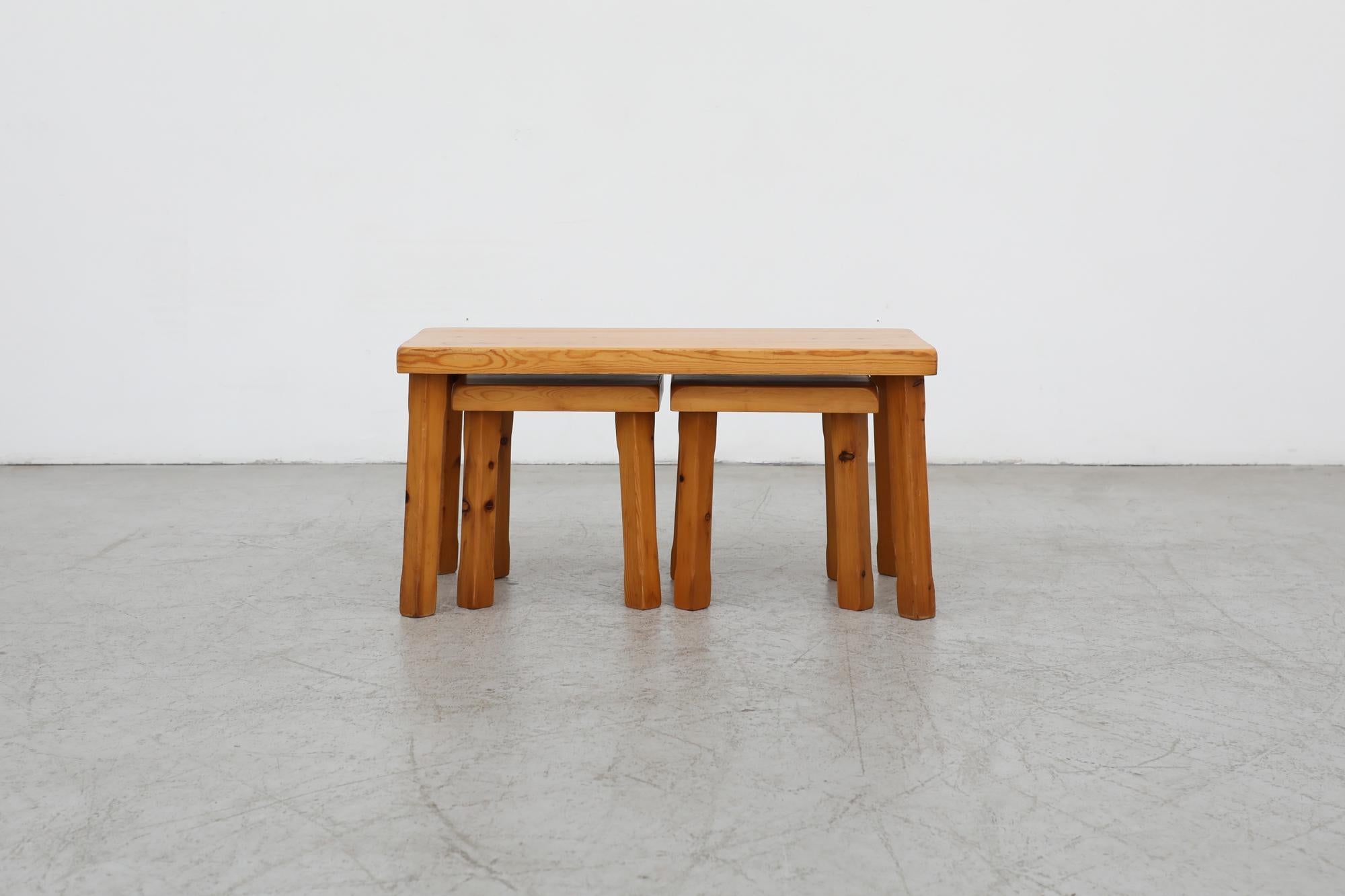 Beautiful set of 3 Charlotte Perriand style brutalist style pine nesting tables with hand carved square legs. One larger main table, with 2 smaller matching square tables (11.75 x 11.75 x 10.75) underneath. In good original condition with wear and