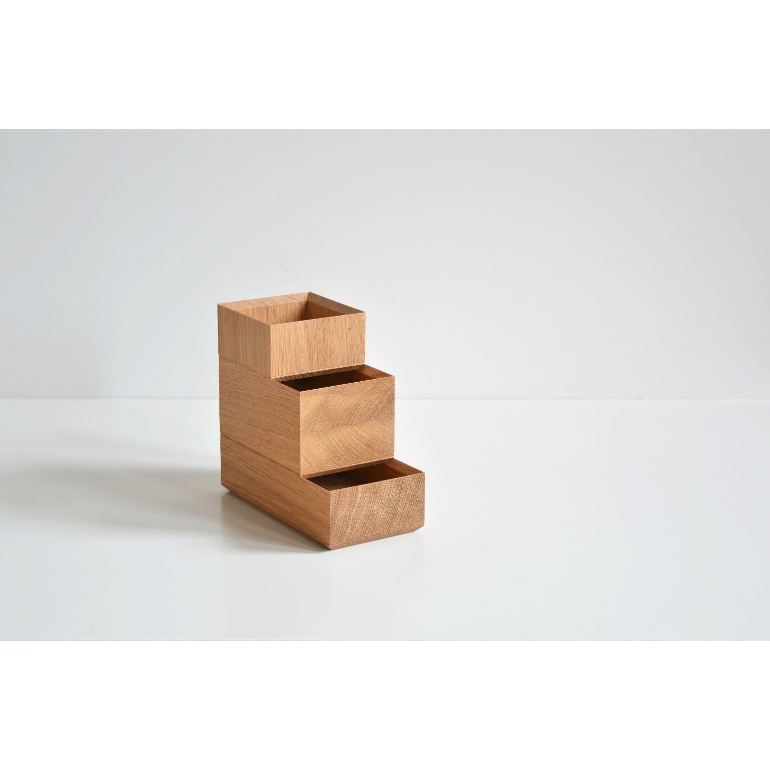 Set of 3 pino boxes by Antrei Hartikainen
Materials: Oak, natural oil wax
Dimensions: D 9, W 9, H 5 / 9,5 / 14cm

A set of three vertical and two horizontal stacking boxes constructed of vividly grained woods. The pino boxes may be arranged in