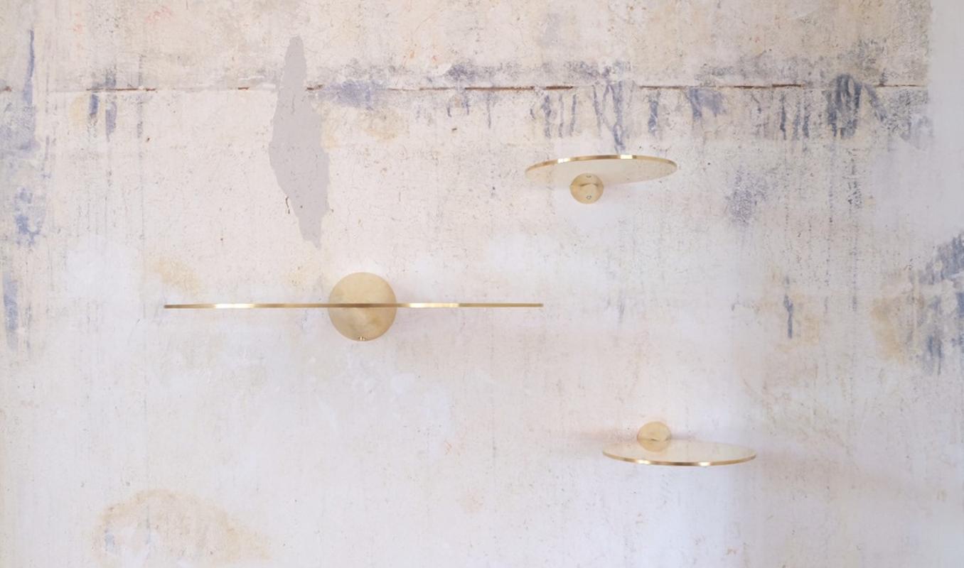 Polished brass floating shelves signed by Chanel Kapitanj
A Minimalist shelving system. Like floating objects on the wall. These thin and aesthetic shelves made of two shapes, a plate and a cone, display your objects in a simple refined