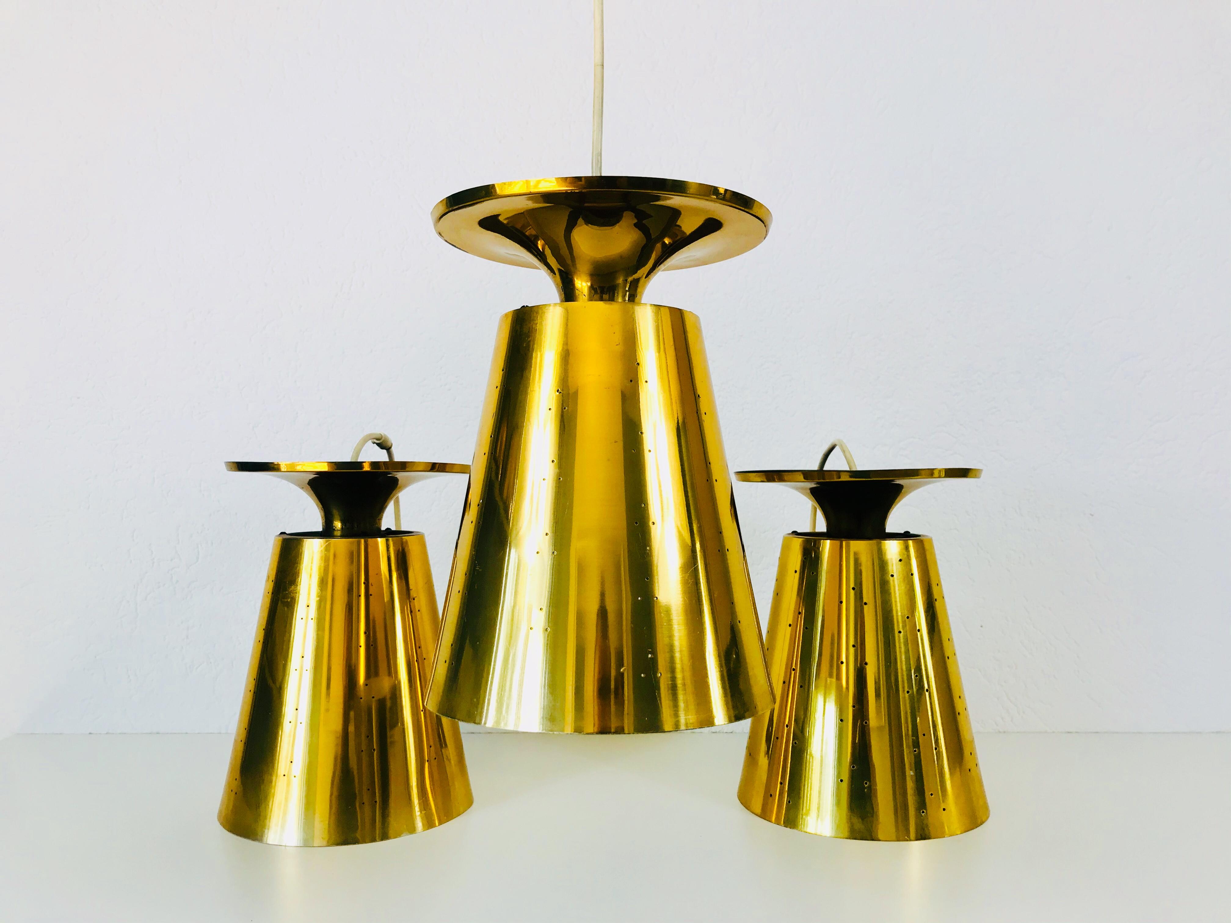 Italian Set of 3 Polished Brass Pendant Lamps Attributed to Paavo Tynell, 1950s For Sale