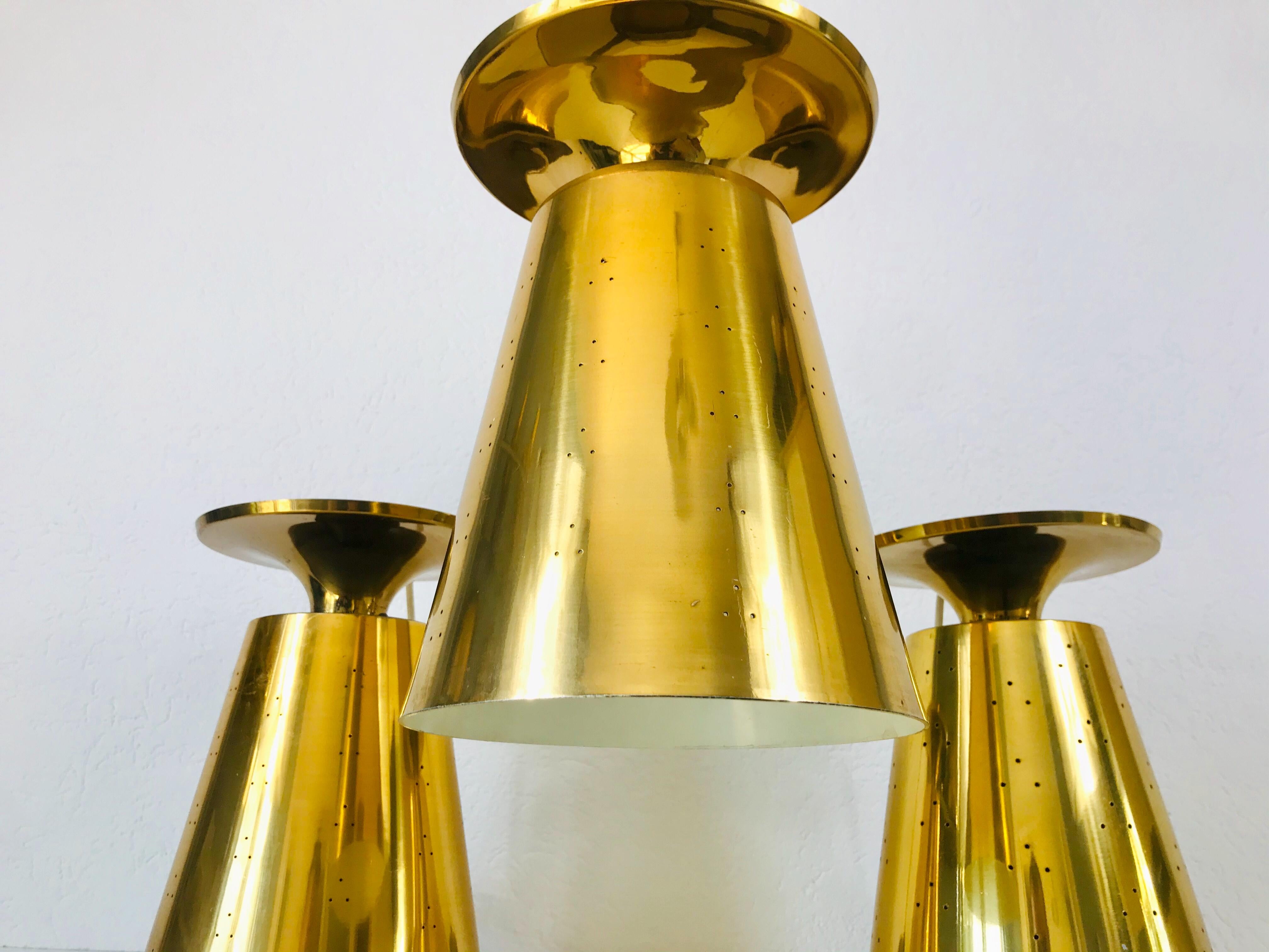 Set of 3 Polished Brass Pendant Lamps Attributed to Paavo Tynell, 1950s In Good Condition For Sale In Hagenbach, DE