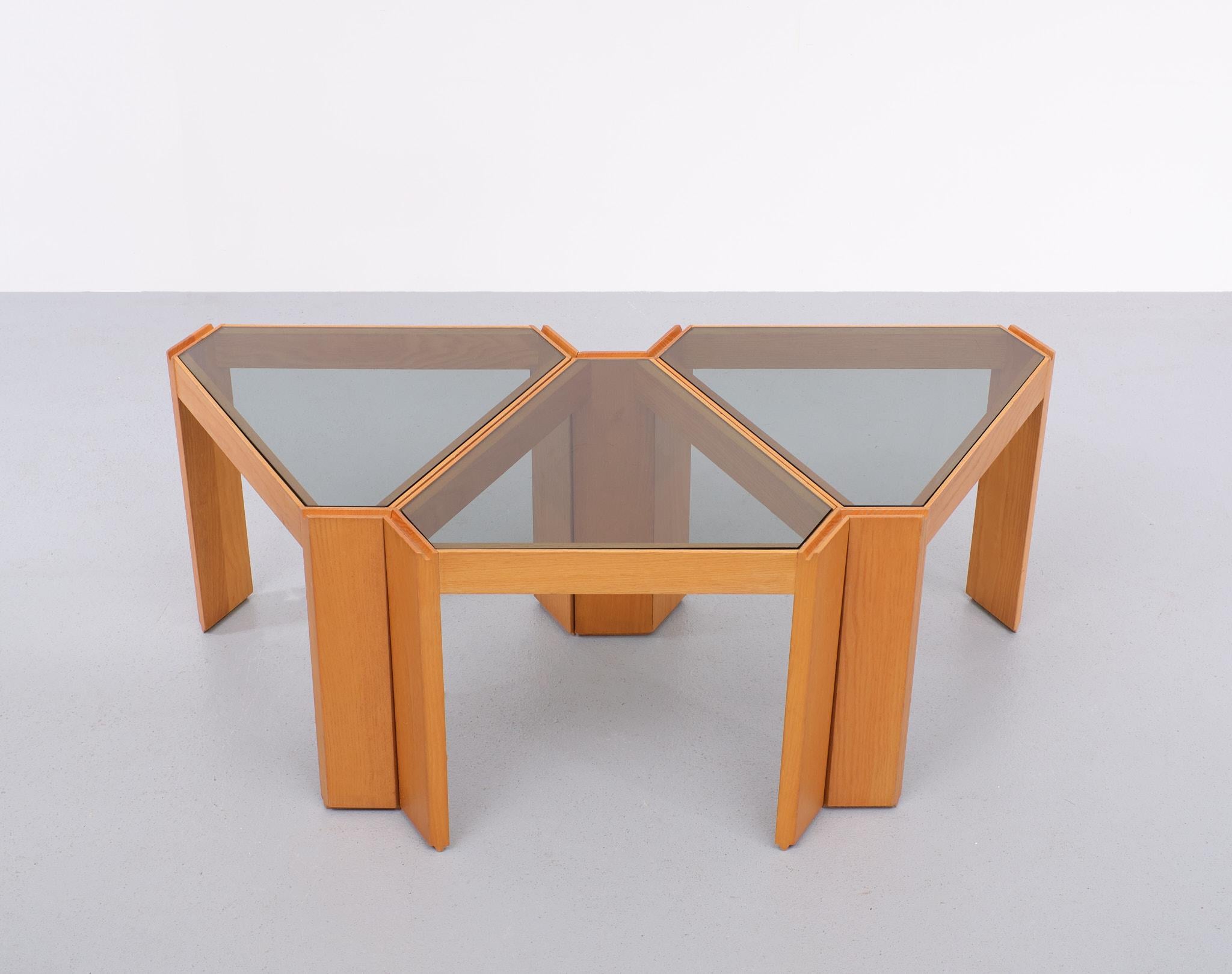 Very nice set of triangle shaped side tables by Porada Arrendi. These beautiful side tables were produced in the 1970s in Italy. They can be arranged in many different forms or stacked on top of each other. They're made from Light Oak wooden frame