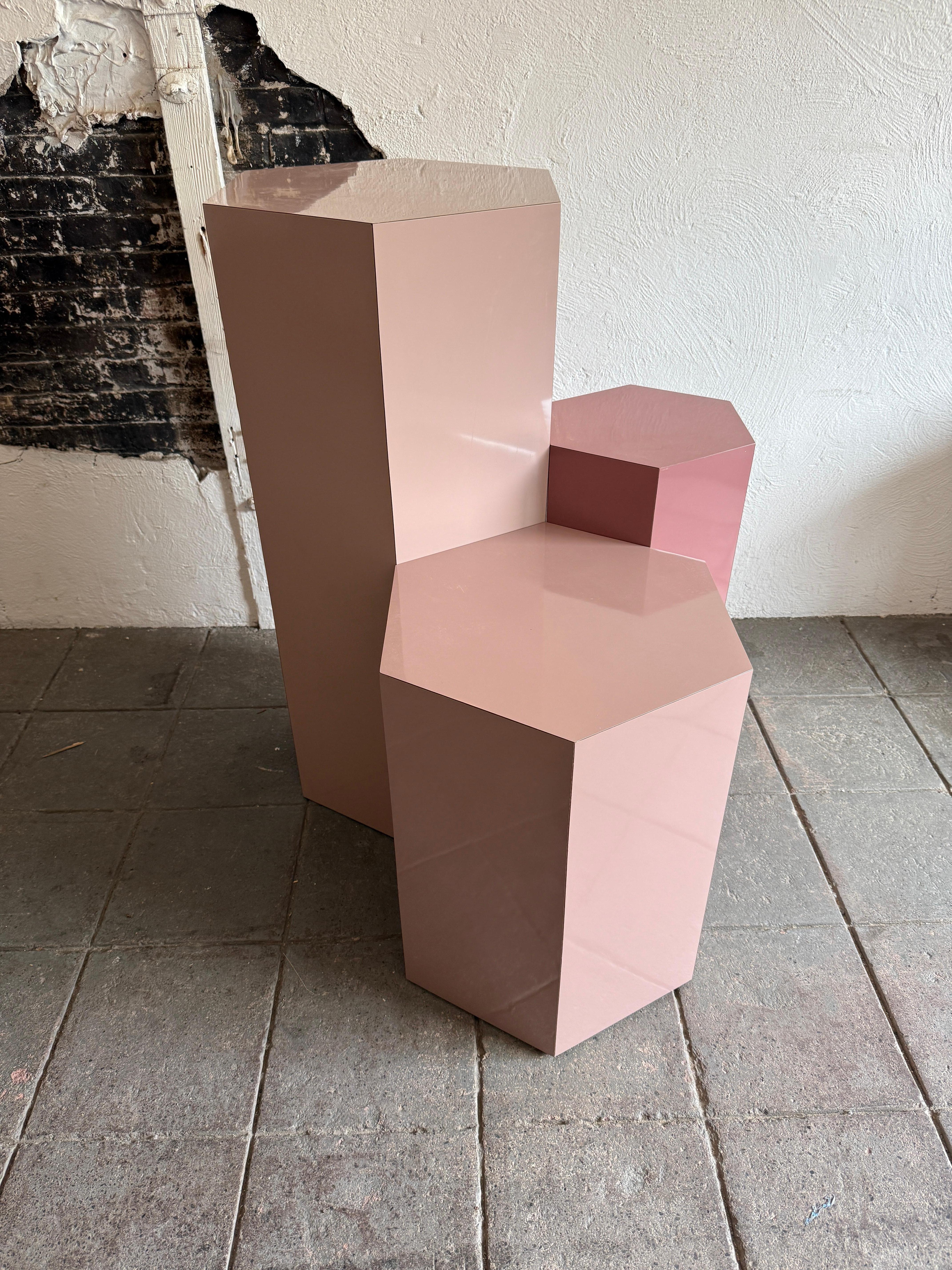Set of 3 post modern pink laminate hexagon pedestals or plinths 

All in great condition 

The largest is 42” high at 18” diameter 

Listing is for the set of 3 pedestals or plinths.

Local pick up available in Brooklyn NYC or Kingston NY