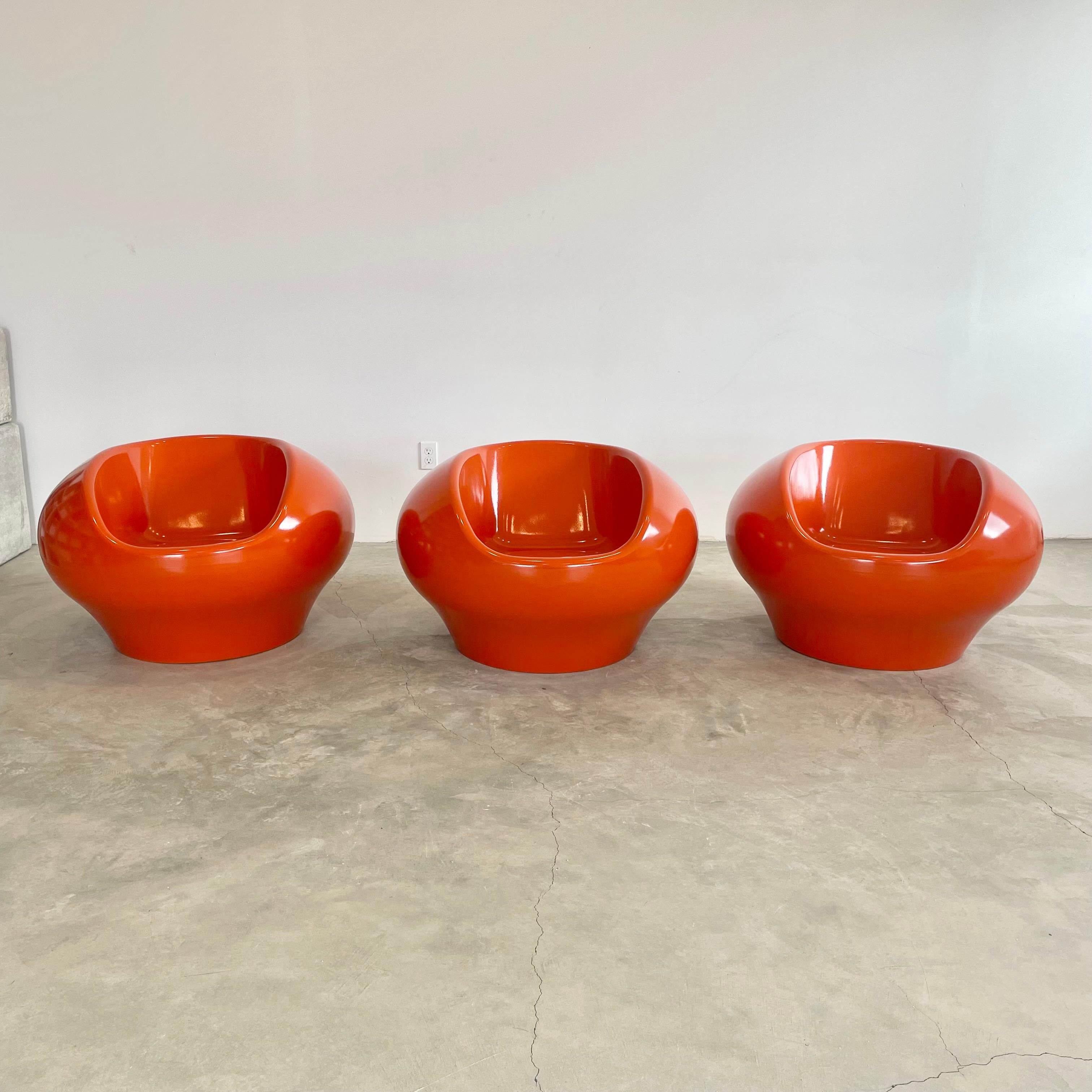 Beautiful set of 3 fiberglass chairs in the style of Eero Aarnio's Pastil chair. Only set we have found to exist with a deep Google search. Handmade and finished in orange. The tapered bottom is a functional improvement to the classic Pastil chair