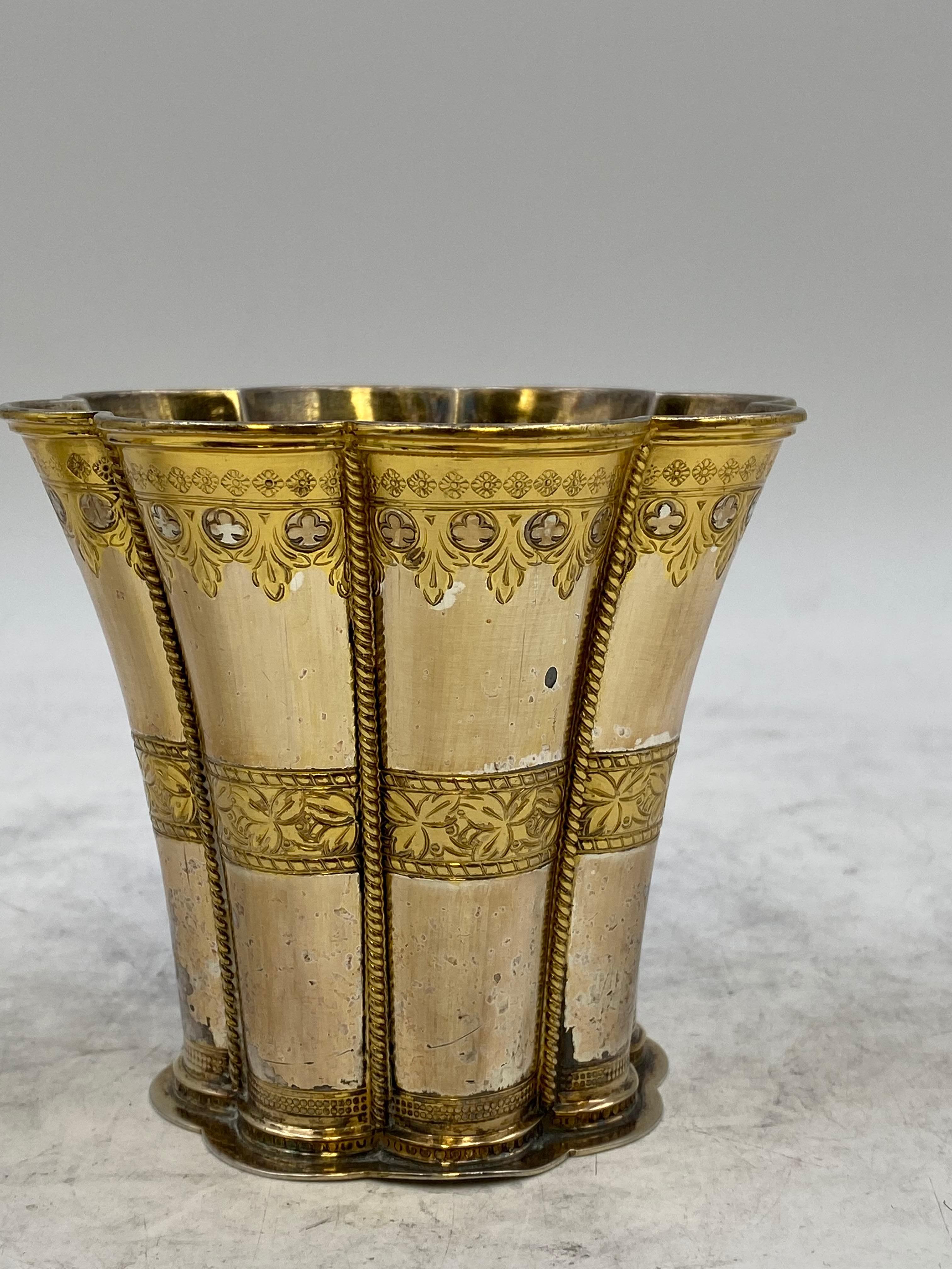 Set of 3 partially gilt sterling silver Kiddush cups/ goblets by A. Michelsen with engraved decorations across and gilt interiors. The tallest one measures 4'' in height by 4 1/4'' in diameter, the medium one is 3 1/2'' high by 3 3/4'' in diameter,