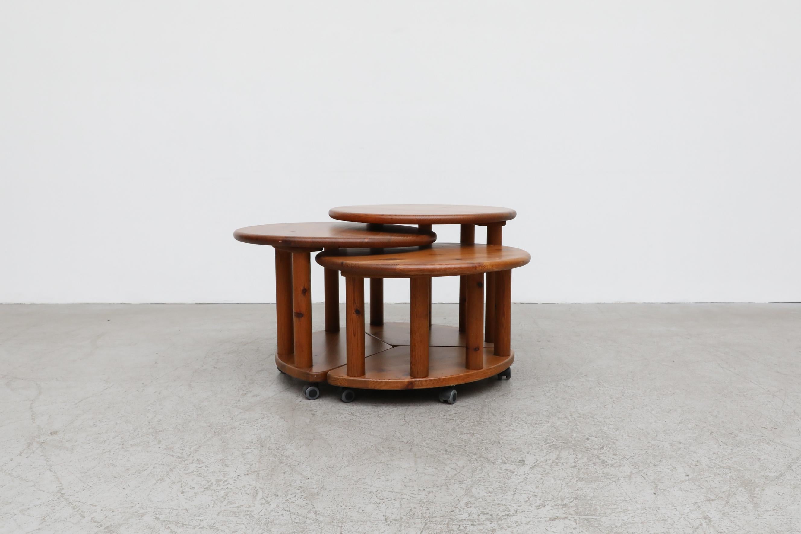 Set of 3 solid pine Rainer Daumiller (attr) round nesting tables on rollers. Each table is 25.25 round. In original condition with visible wear. Wear is consistent with its age and use.