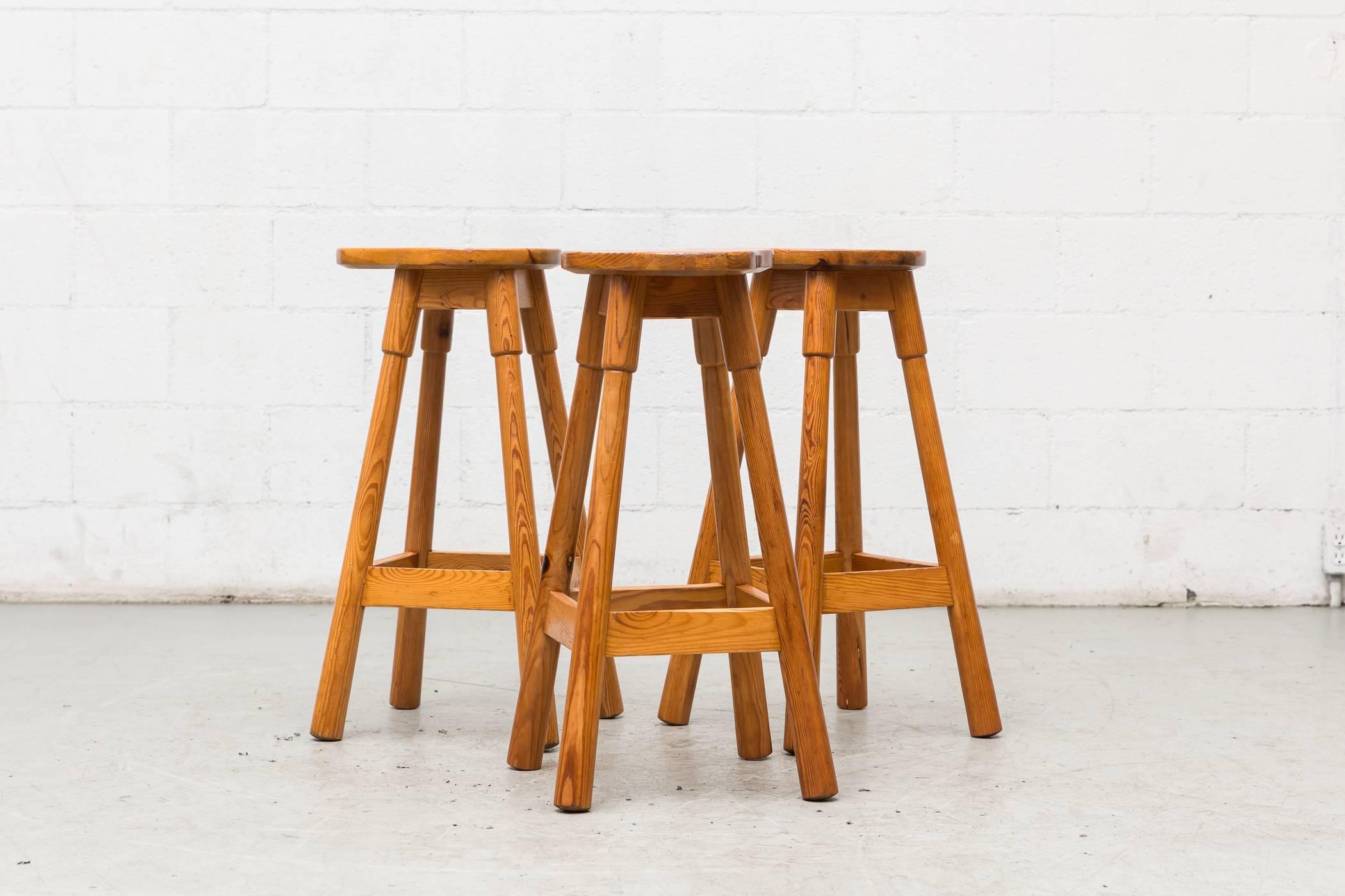 Set of three tall pine bar stools with pear shaped seats, footrests by Rainer Daumiller. Lightly refinished. Set price.