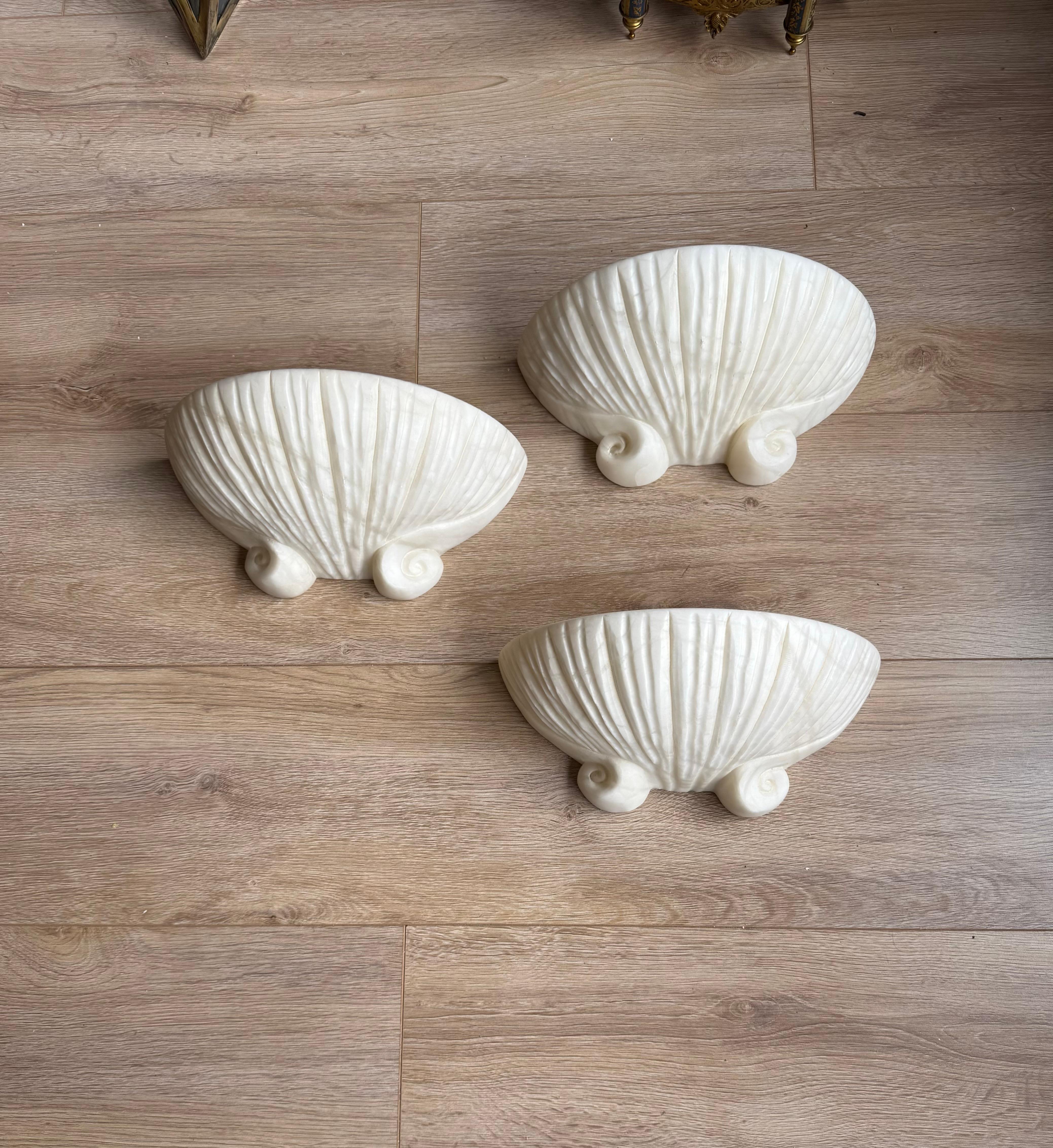 Handcrafted and very rare set of midcentury for beach house, shell shape design alabaster wall lights.

If you are looking for a great design and practical size set of sconces to grace your living space or beach house then these natural mineral