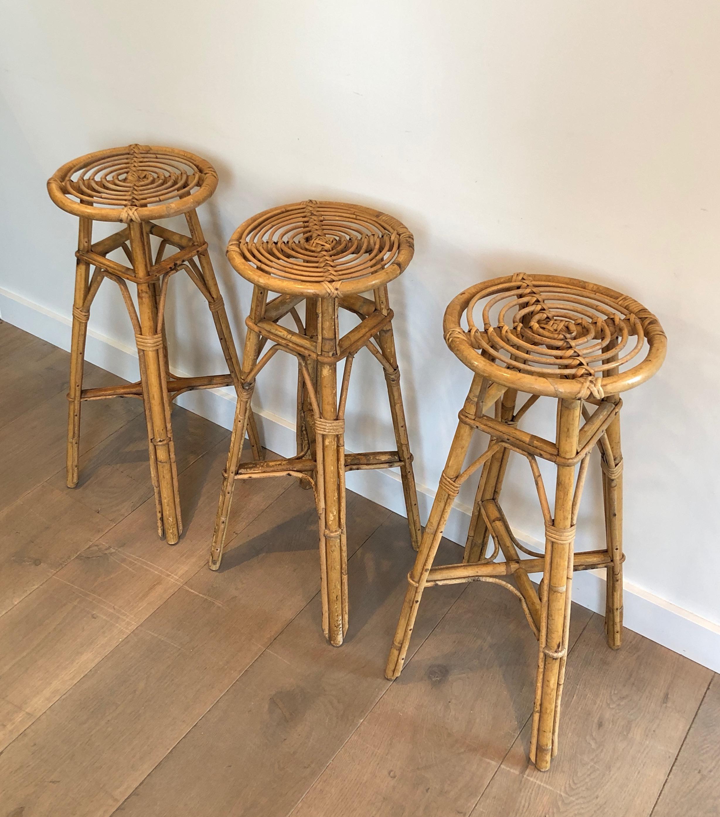 This is a nice set of 3 rattan stools. This is a French work, circa 1970.