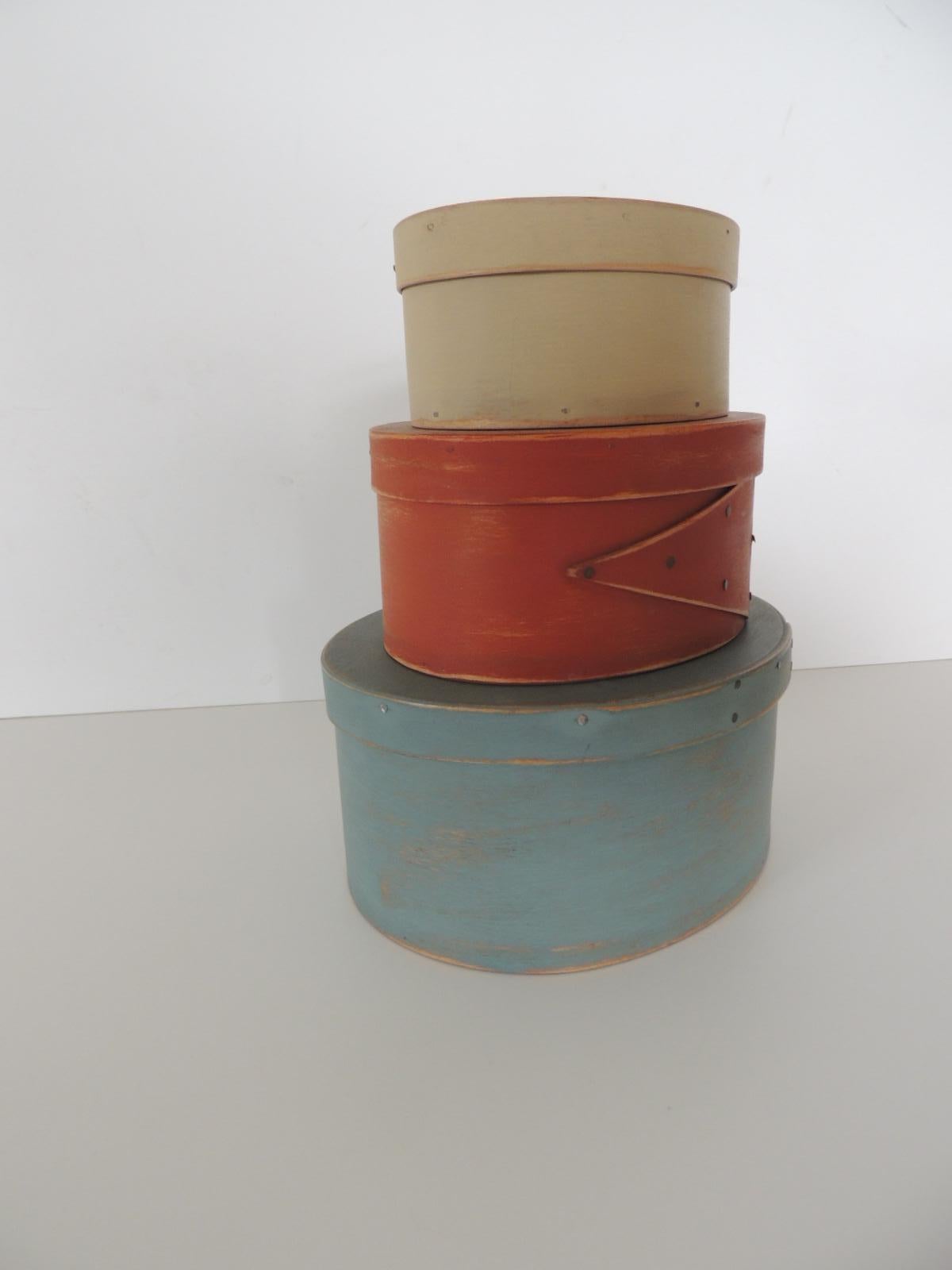 Set of 3 red, blue and tan wooden shaker boxes.
Three lidded oval hand painted storage boxes/caddies.
Sizes: from top.
5 .1/4