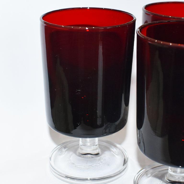 A set of French 3 ruby red cordial glasses by Luminarc. Marked at the bottom is 