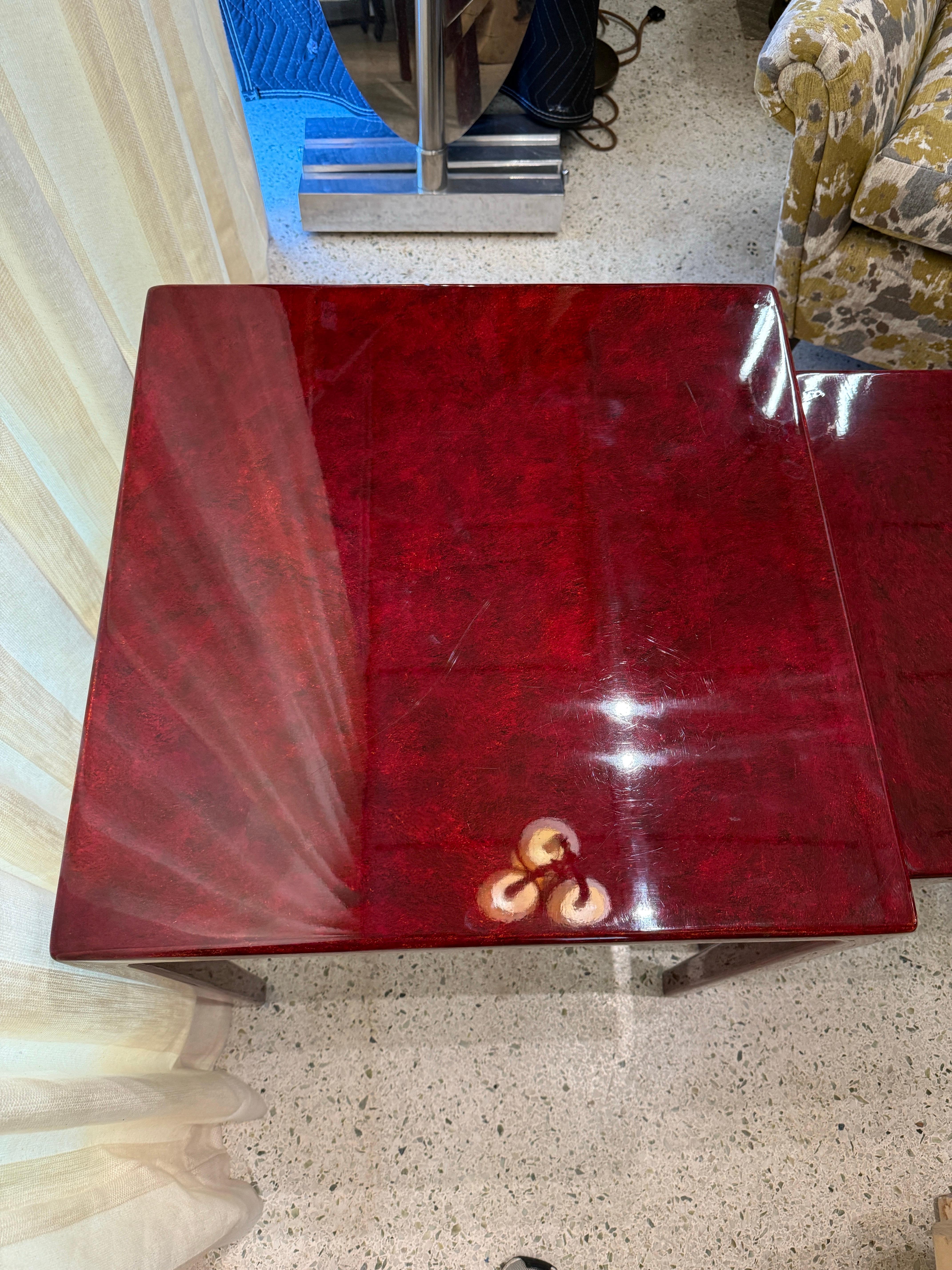 Very high-gloss lacquer in rich burgundy/red with tapering legs.  Exceptional scale for side tables.

NOTE: dimensions of 3 tables are 26.5 inches tall, 23.75 x 23.75 (largest + squared top), 24.5 inches tall, 19.5 x 19.5 (middle table), 22.5 inches