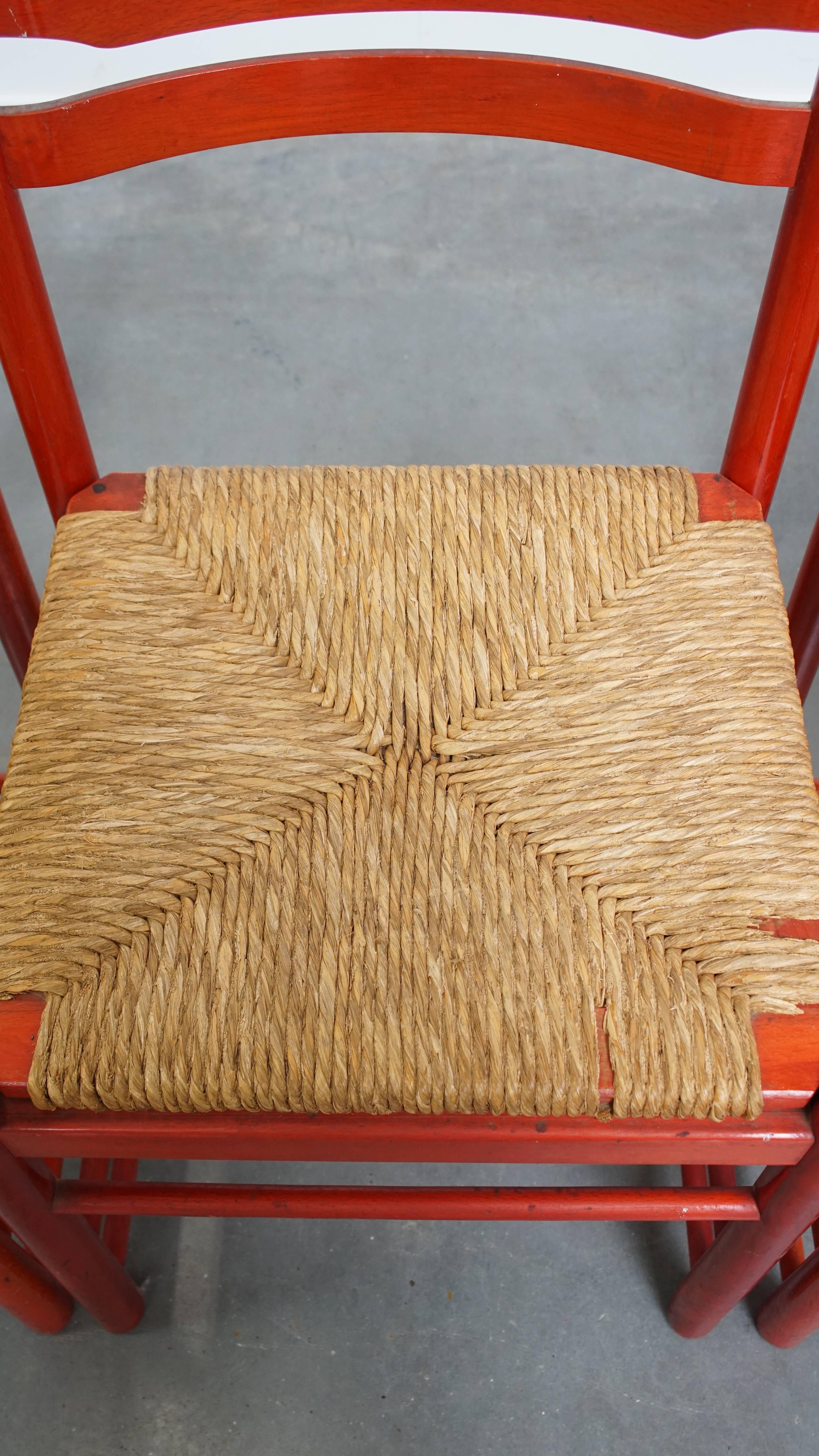 Set of 3 red vintage wooden chairs from the 1970s with a woven wicker seat For Sale 1
