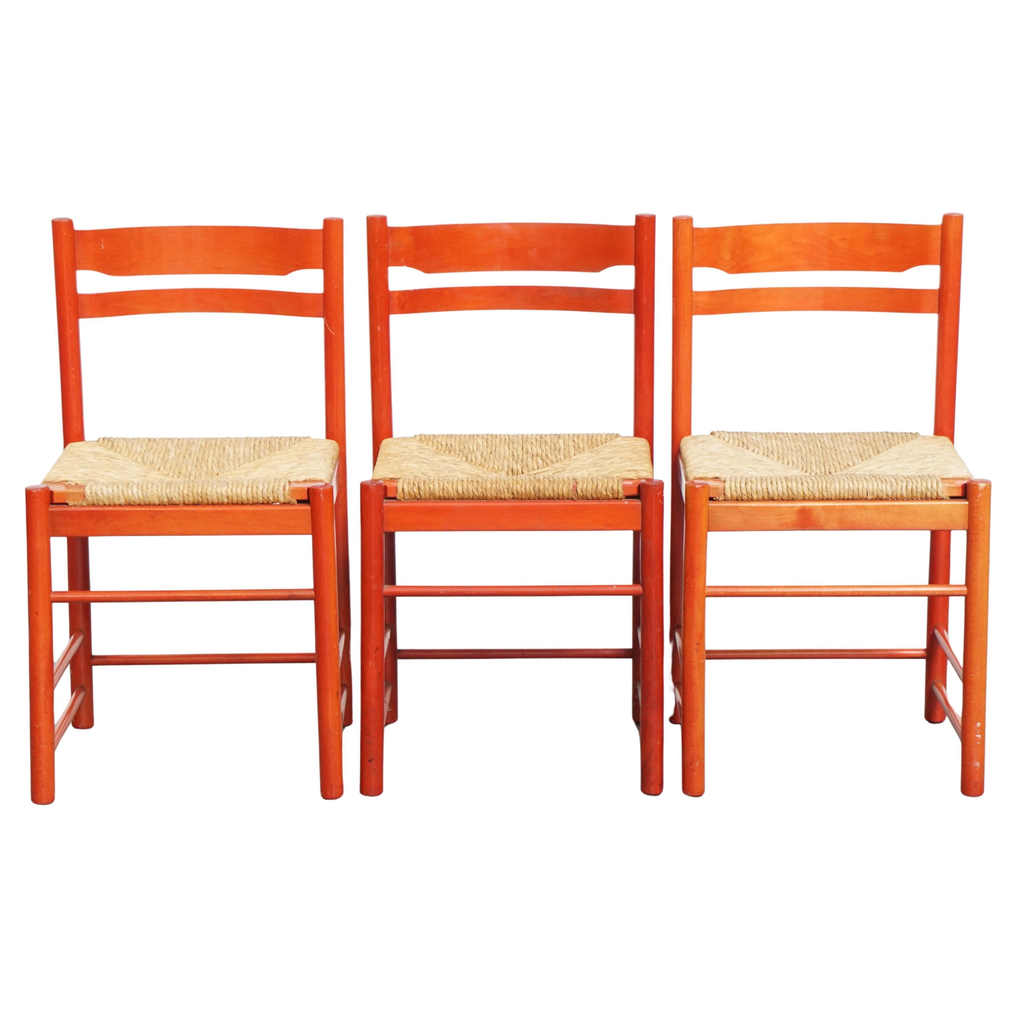 Set of 3 red vintage wooden chairs from the 1970s with a woven wicker seat For Sale