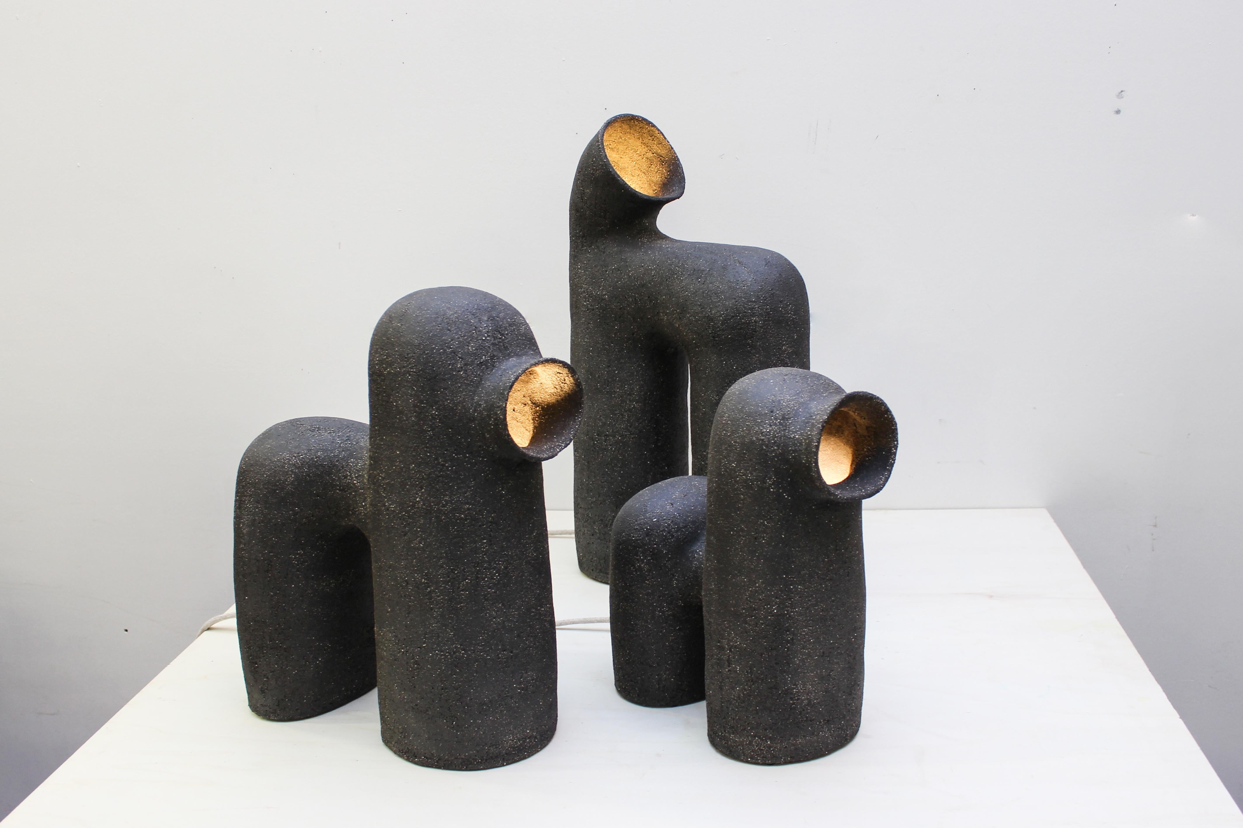 Set of 3 refuge black stoneware table lamp by Elisa Uberti
Materials: Black stoneware
Dimensions: Around 55/60cm

After fifteen years in fashion, Elisa Uberti decides to take the time to work with these hands and to give birth to new