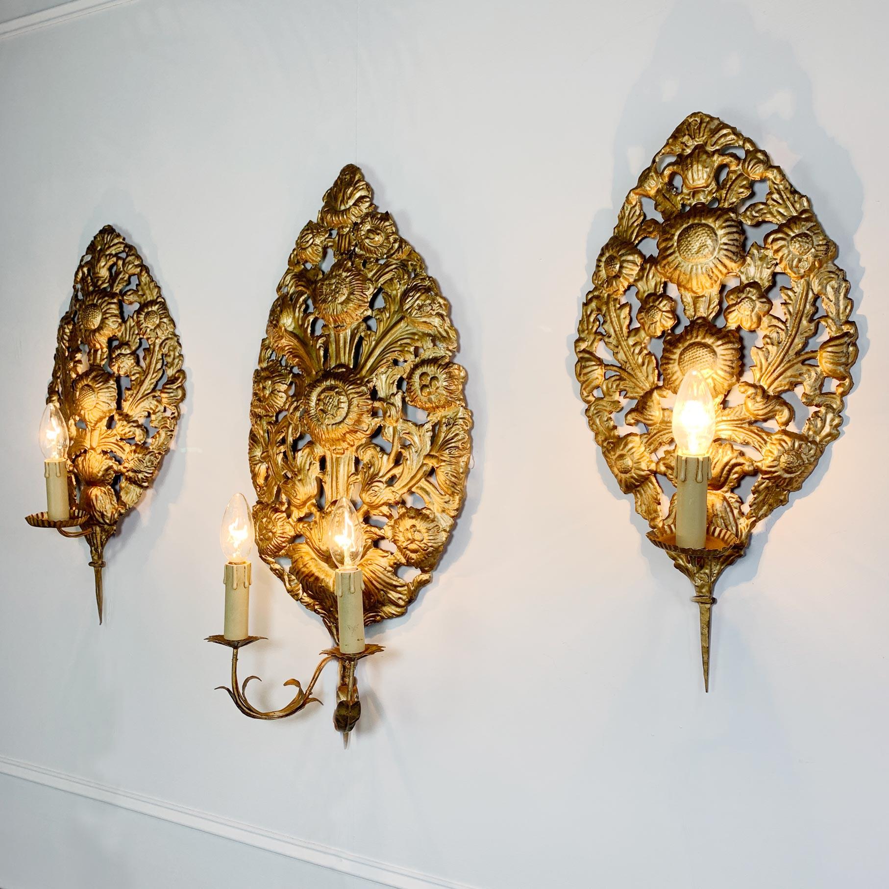 A rare set of 3 Brass Baroque repousse wall sconces

Original late 17th/ early 18th century large detailed Repoussé back plates designed with high relief of scrolling foliage and large sunflower heads. Original Iron Framework to the reverse. These