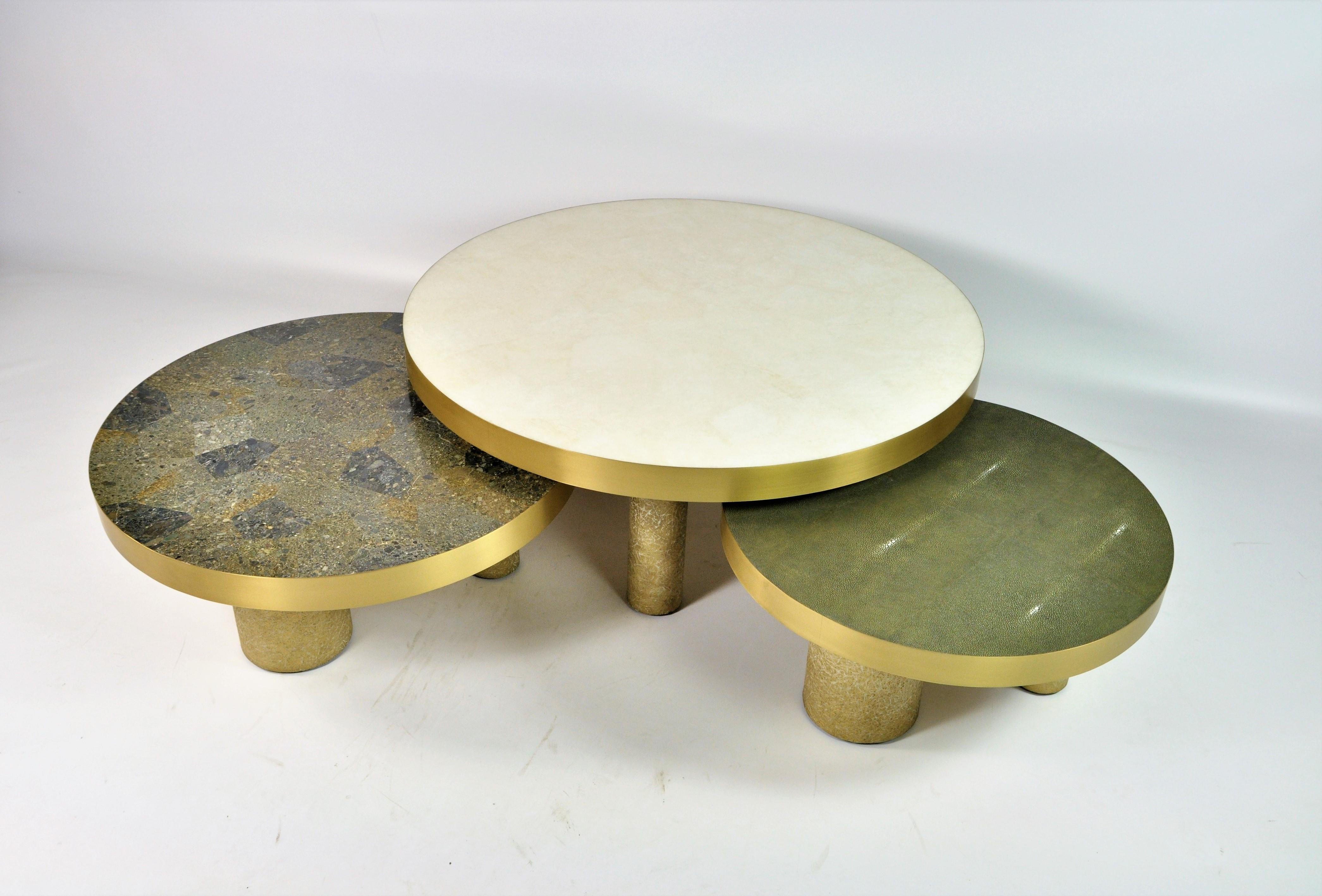 This set of 3 coffee tables is made of various inlaid materials.
These modular tables can be setted up following your wishes.
The center piece is covered with a polished white rock crystal marquetry, the side tables are inlaid with shagreen and