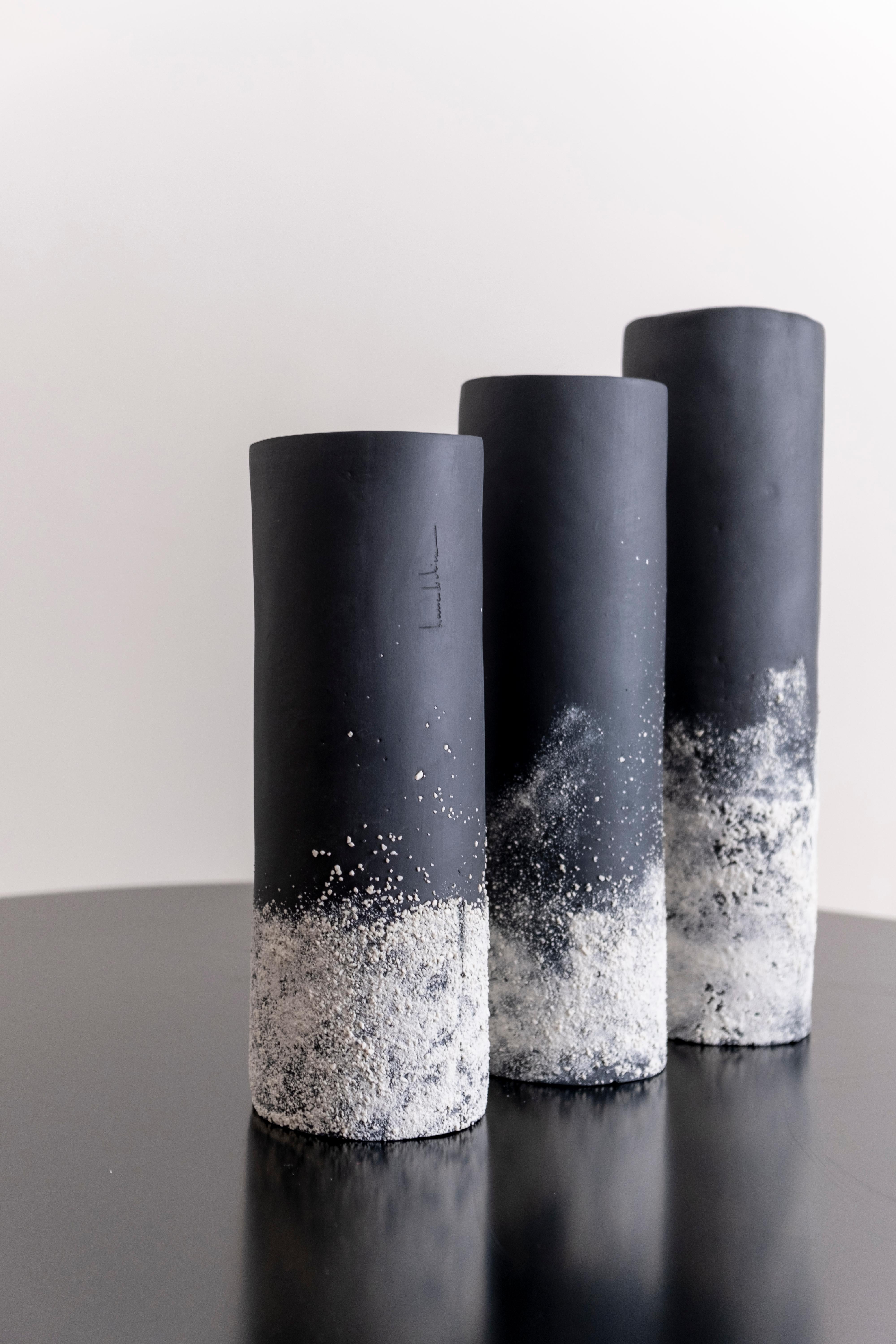 Set of 3 sand vases by Alice Reina Biancodichina
Dimensions: 
Small 9,5 x H 28cm
Medium 9,5 x H 31cm
Large 9,5 x H 35cm. 
Materials: Limoges porcelain, pigment, glaze. 

Technique: Slab building technique. The “sand effect” is made of