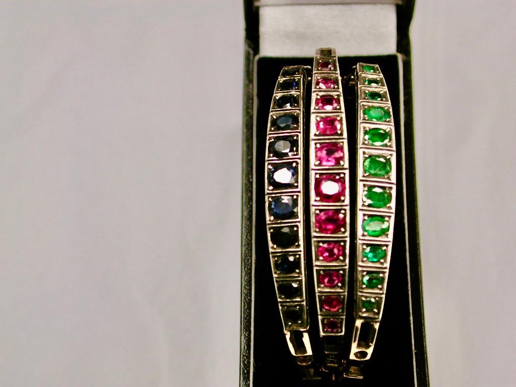 Set Of 3 Sapphire,Ruby,& Emerald Set 14 Ct Gold Bangles,Dated Circa 1940's
Can be worn separately, all together or two at a time.
The effect together is spectacular.
Each one has a tongue and groove snap with a safety catch.
All the precious stones
