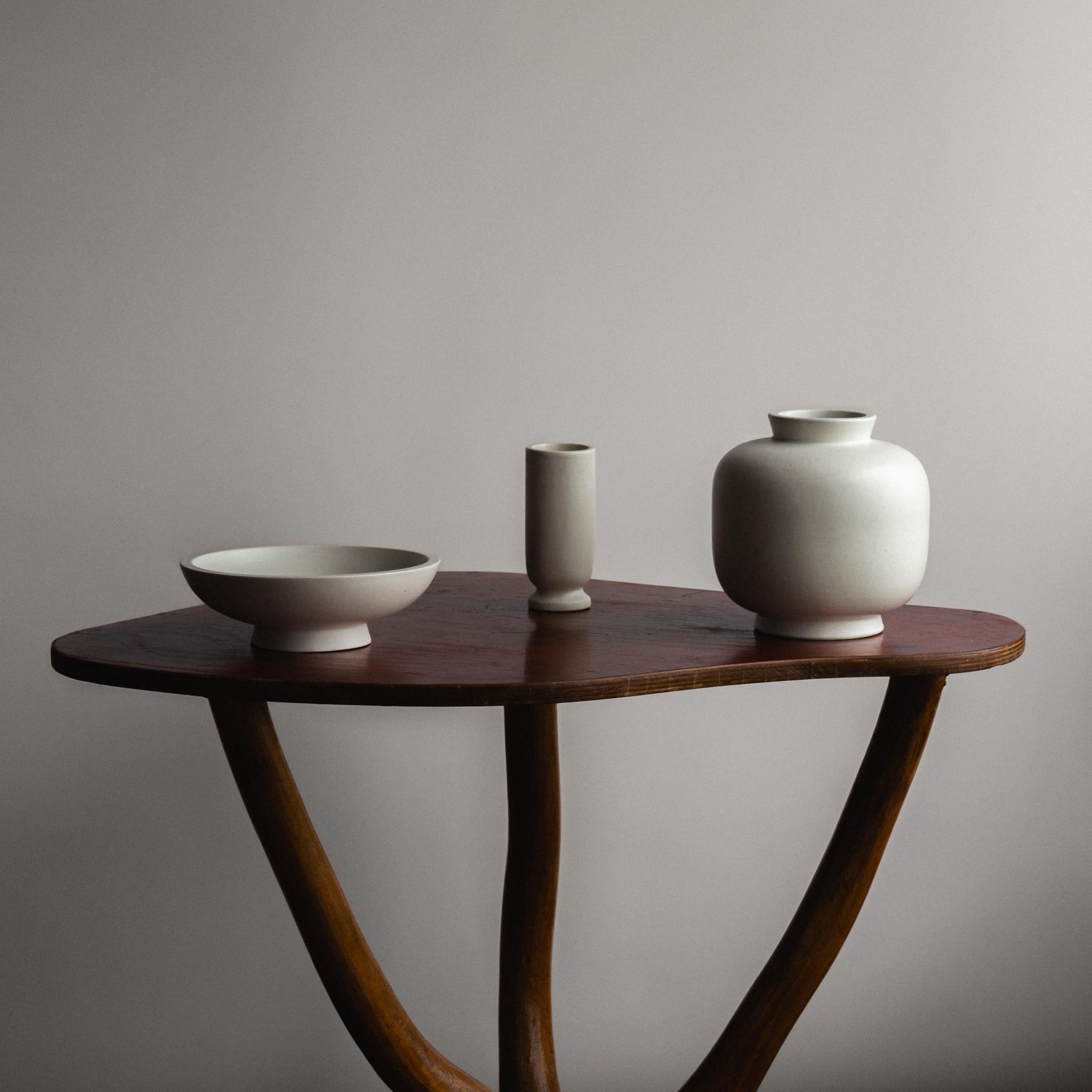 A beautiful set of Swedish Modern pottery vases and bowl with matte white 'Carrara' glaze. Hand turned, designed by Wilhelm Kåge at Gustavsberg in Sweden.

Crafted with meticulous attention to detail, the Carrara series exudes an air of timeless