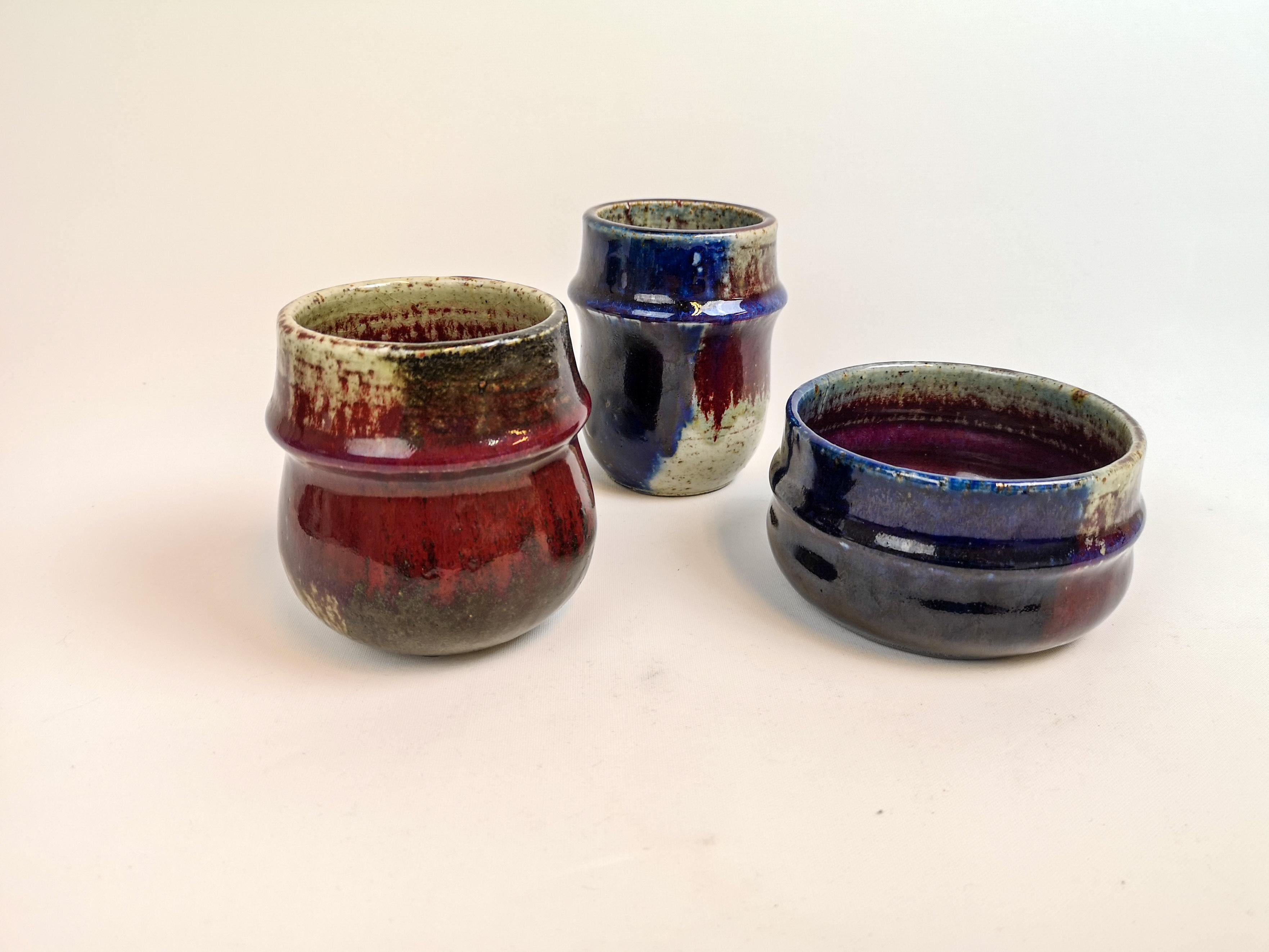 This set containing 3 pieces ceramic was designed by Sylvia Leuchovius and produced by Rörstrand. These three pieces are marked as studio ceramic and are well sculptured with a stunning glaze. They all shift in color as the glaze give them all that
